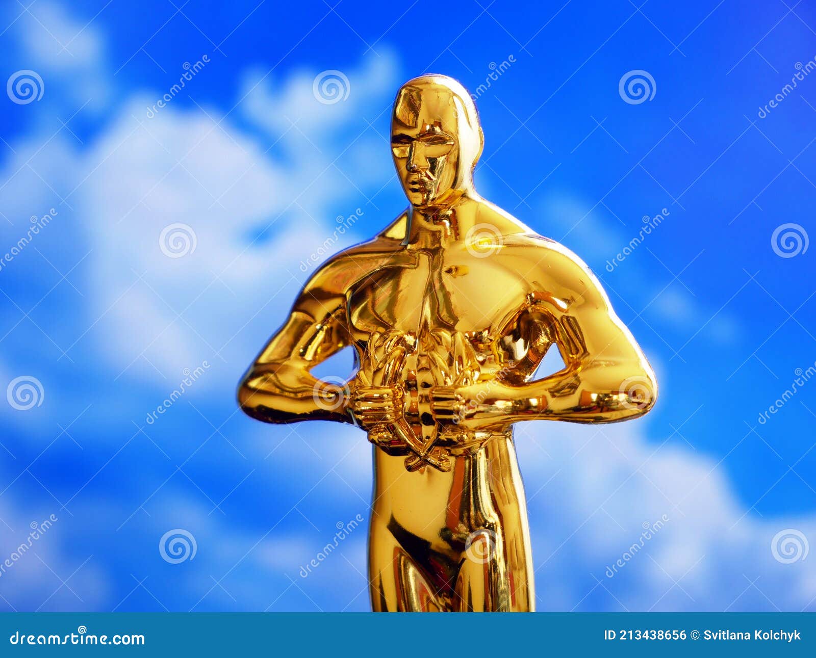 Hollywood Golden Oscar Academy Award Statue on Blue Sky Background with