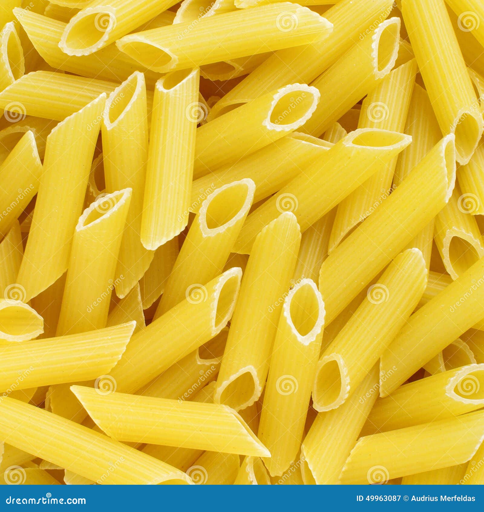 golden penne rigate italian pasta texture background