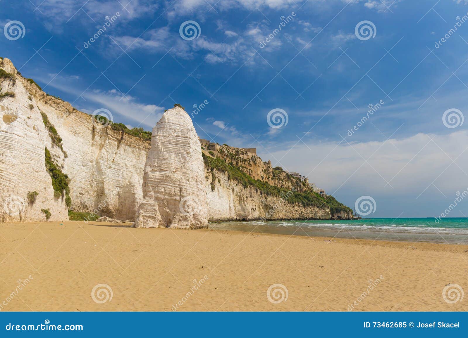 golden sand beach of vieste with pizzomunno rock, gargano peninsula, apulia, south of italy