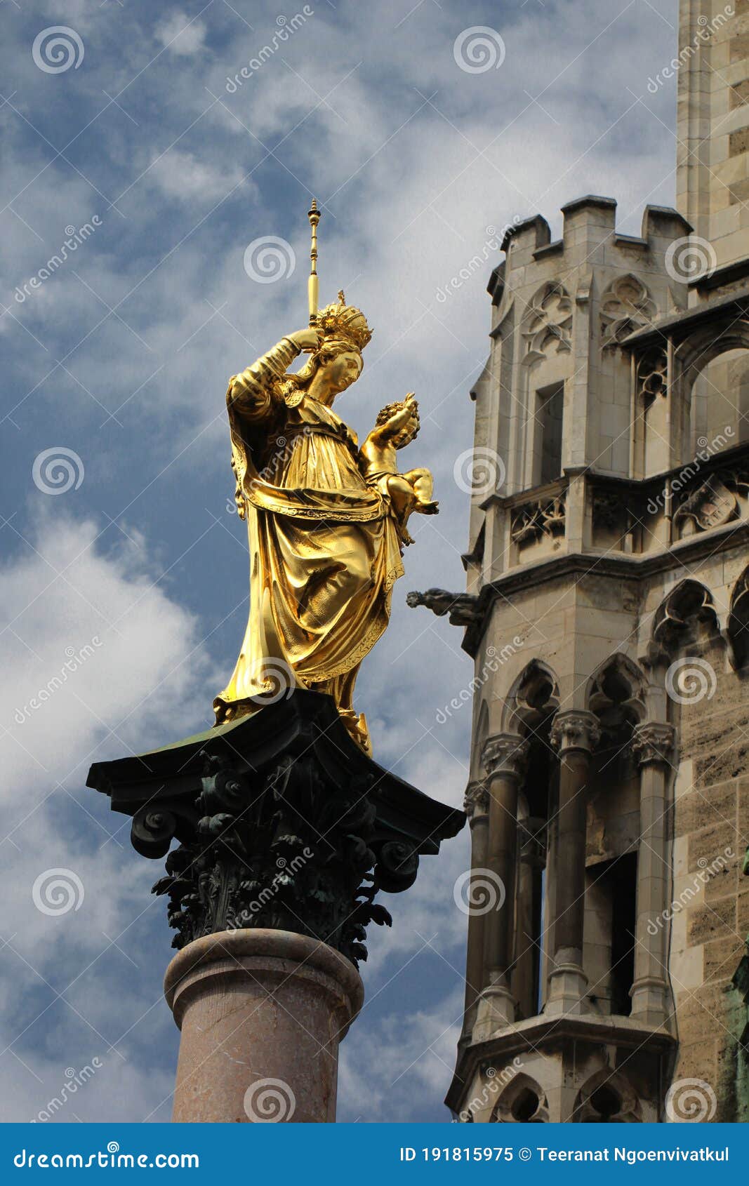 golden scuplture of virgin mary at  marienplatz under blue sky backgrounds, munich, germany, travel