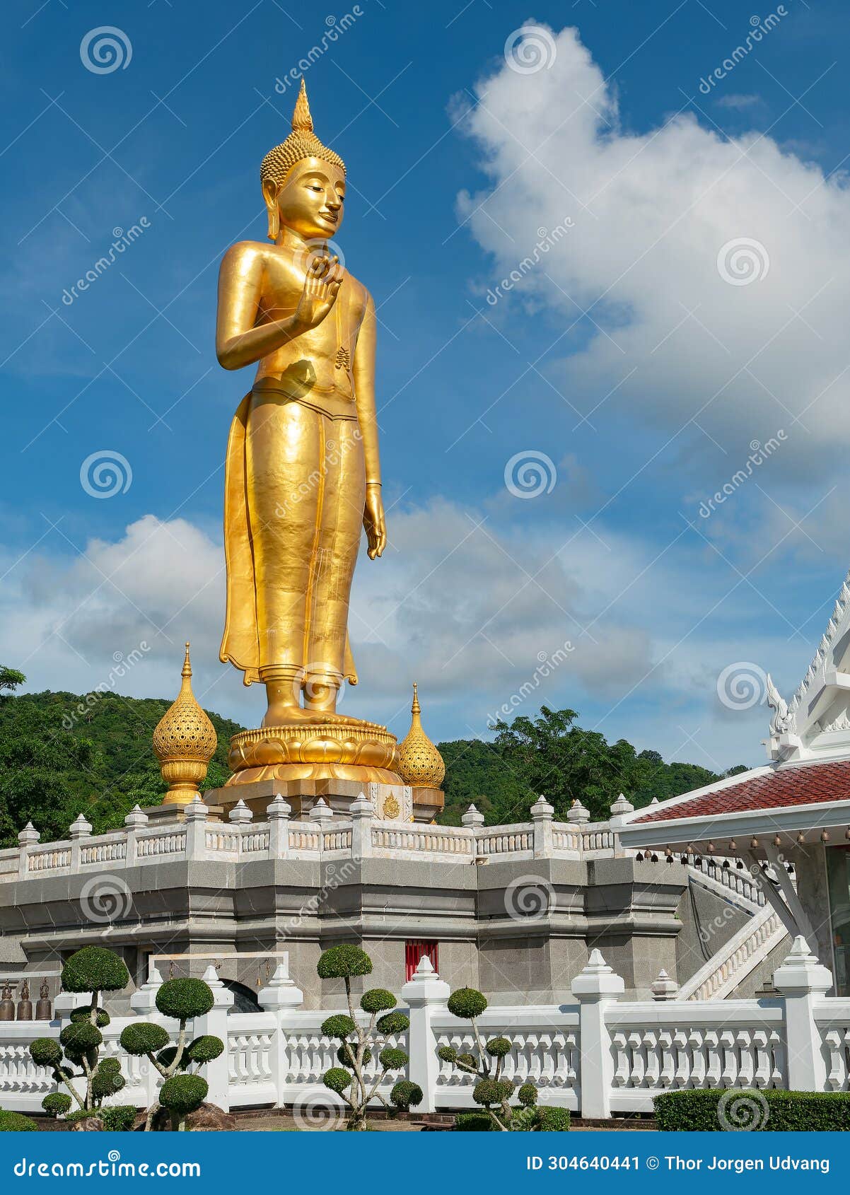 golden standing buddha in hat yai, thailand