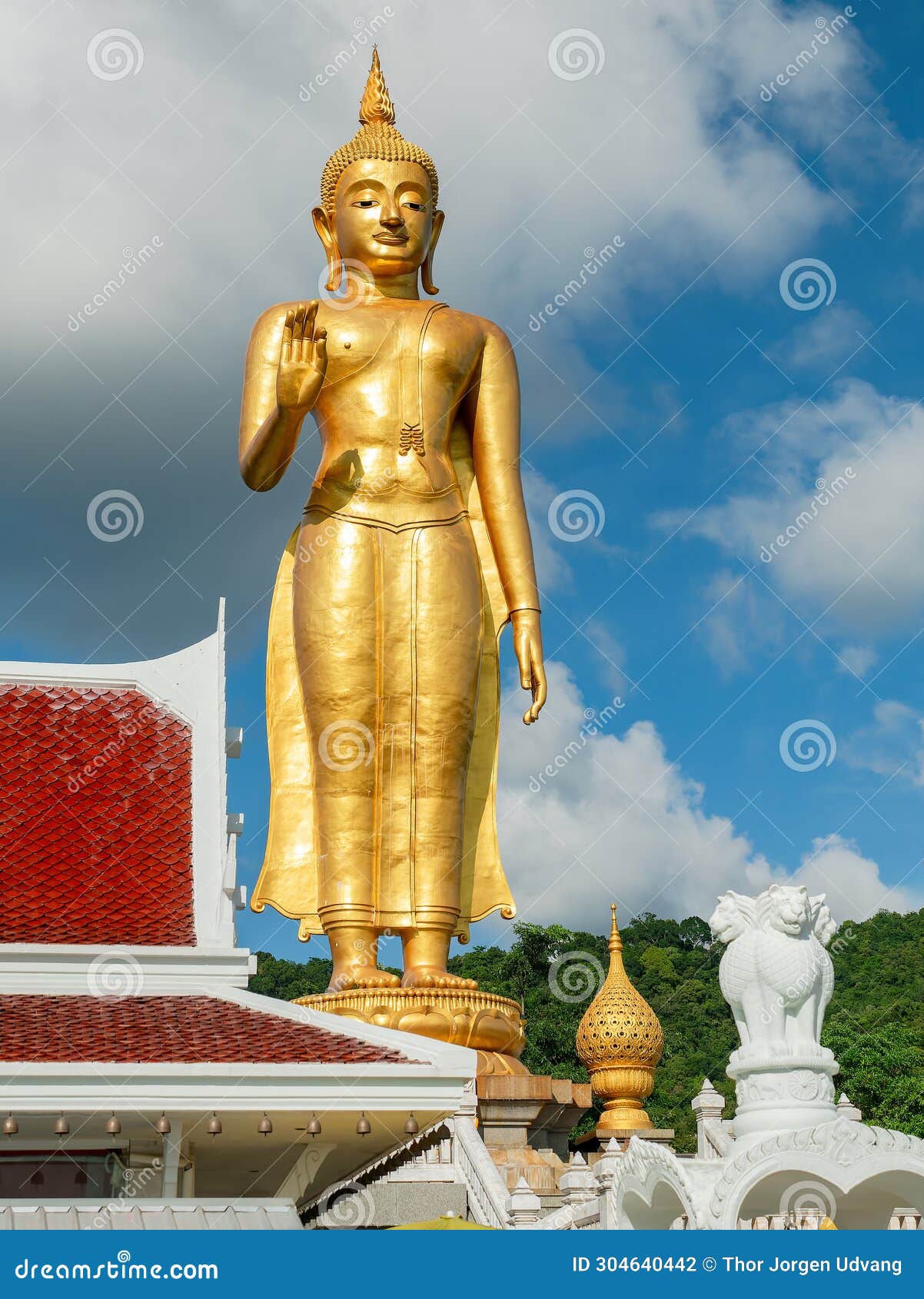 golden standing buddha in hat yai, thailand