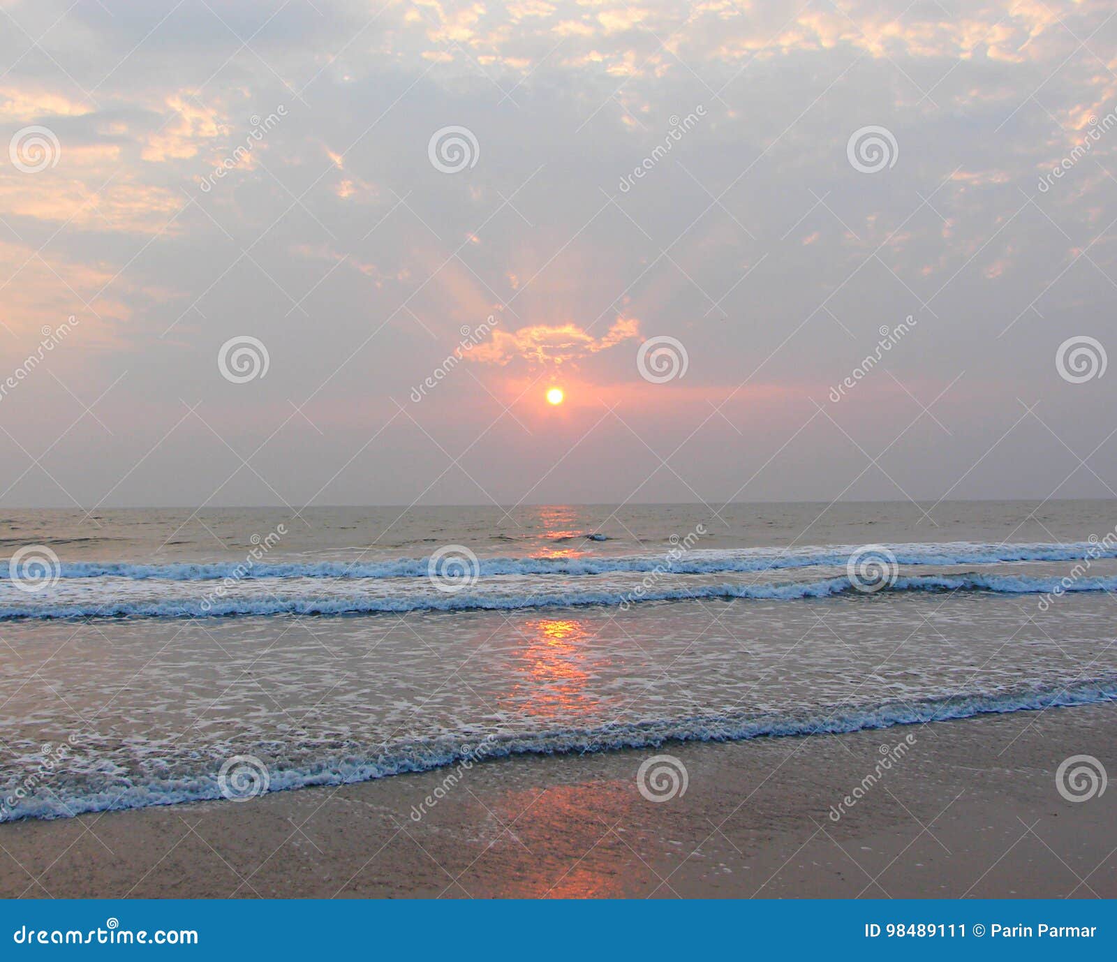 golden sun, sunrays through clouds and reflection in sea water - payyambalam beach, kannur, kerala, india