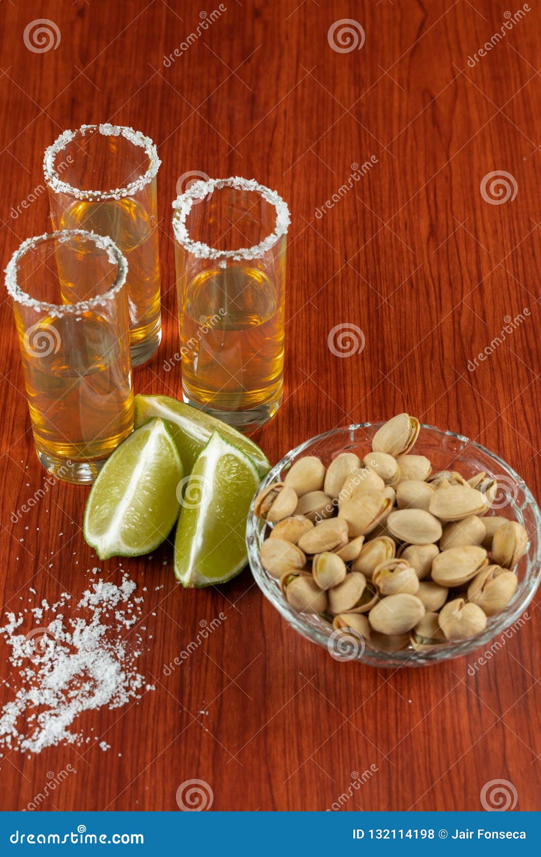 golden tequila with lemon, pistachos, cacahuate, and salt. drinks, liquor