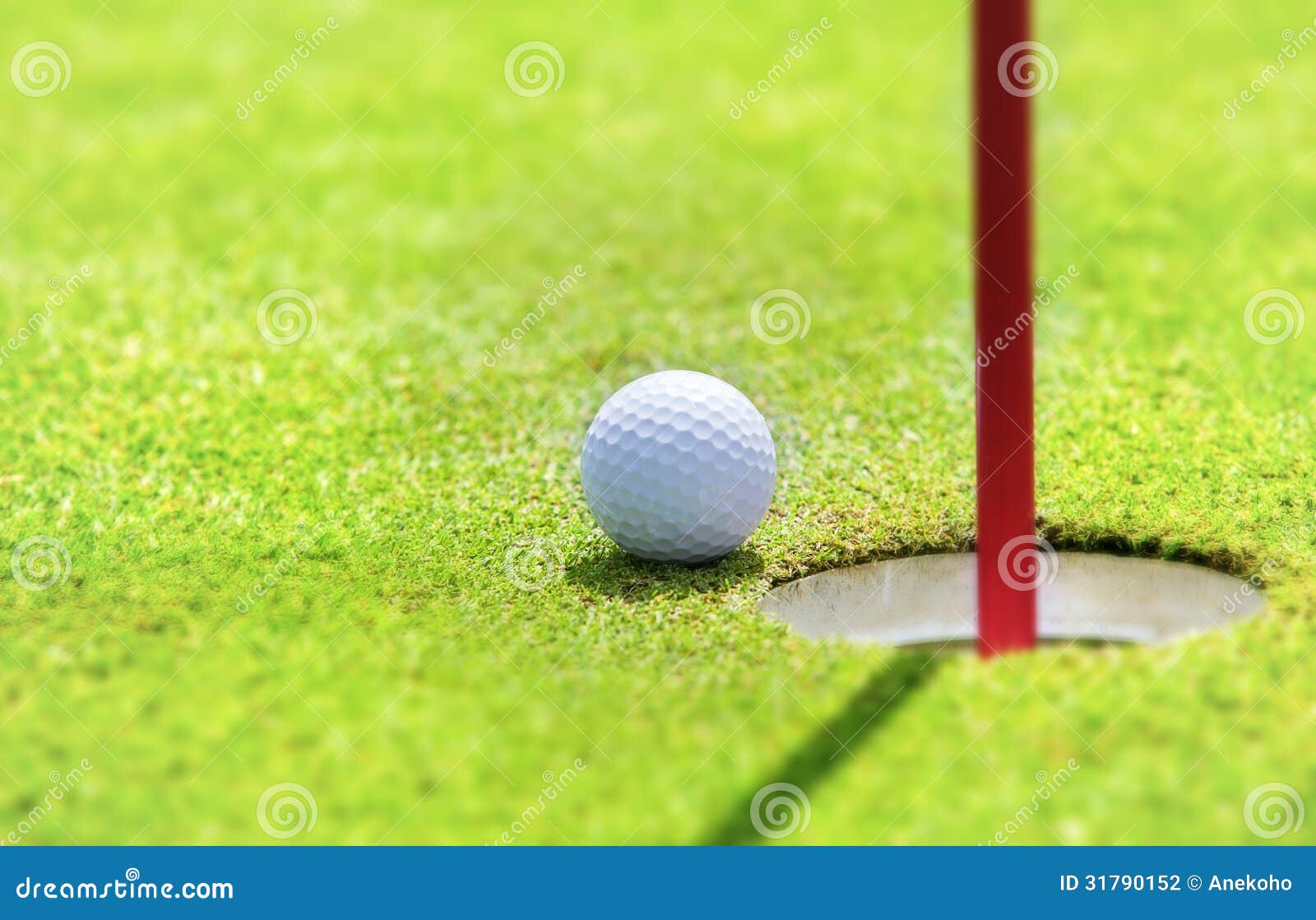 Golf ball on lip of cup