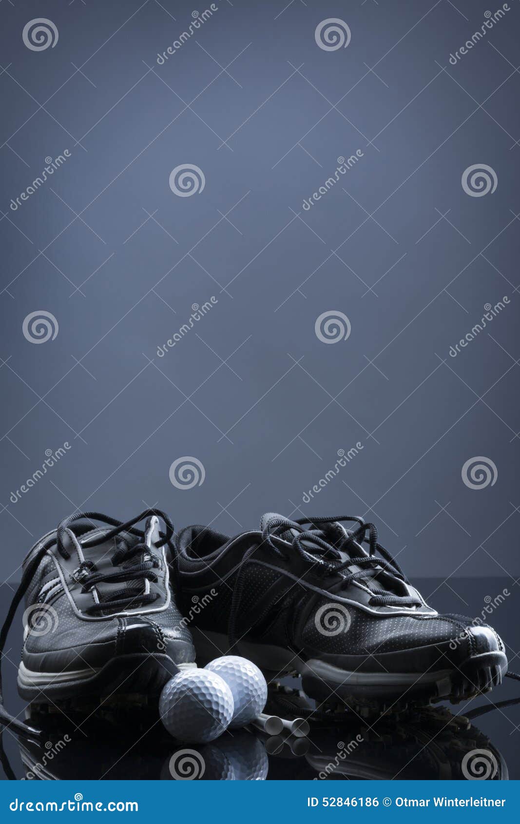 Golf Balls, Tees and Shoes on Dark Blue Background. Stock Photo Image