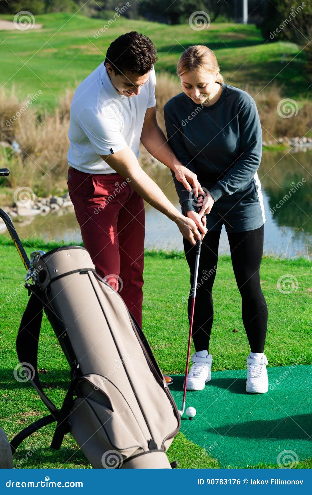 Golf Coach Explains the Basics of a Golfer Hitting the Ball Stock Photo