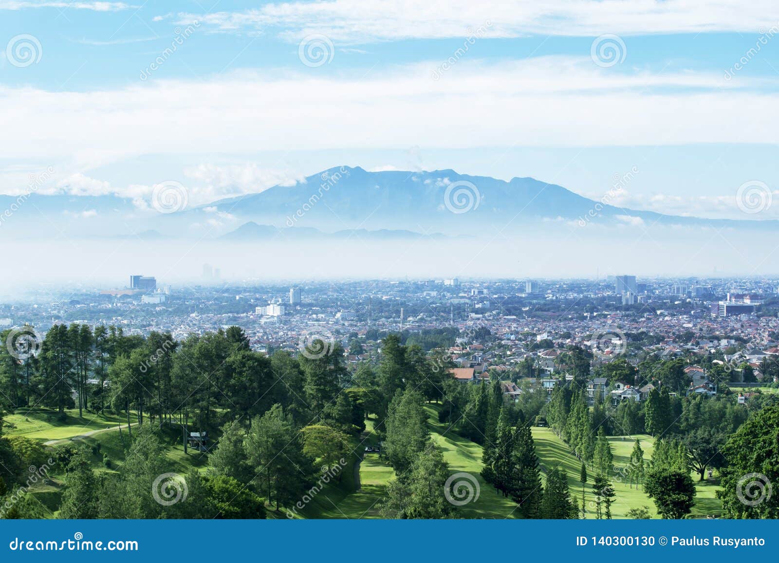 golf course with misty bandung cityscape background