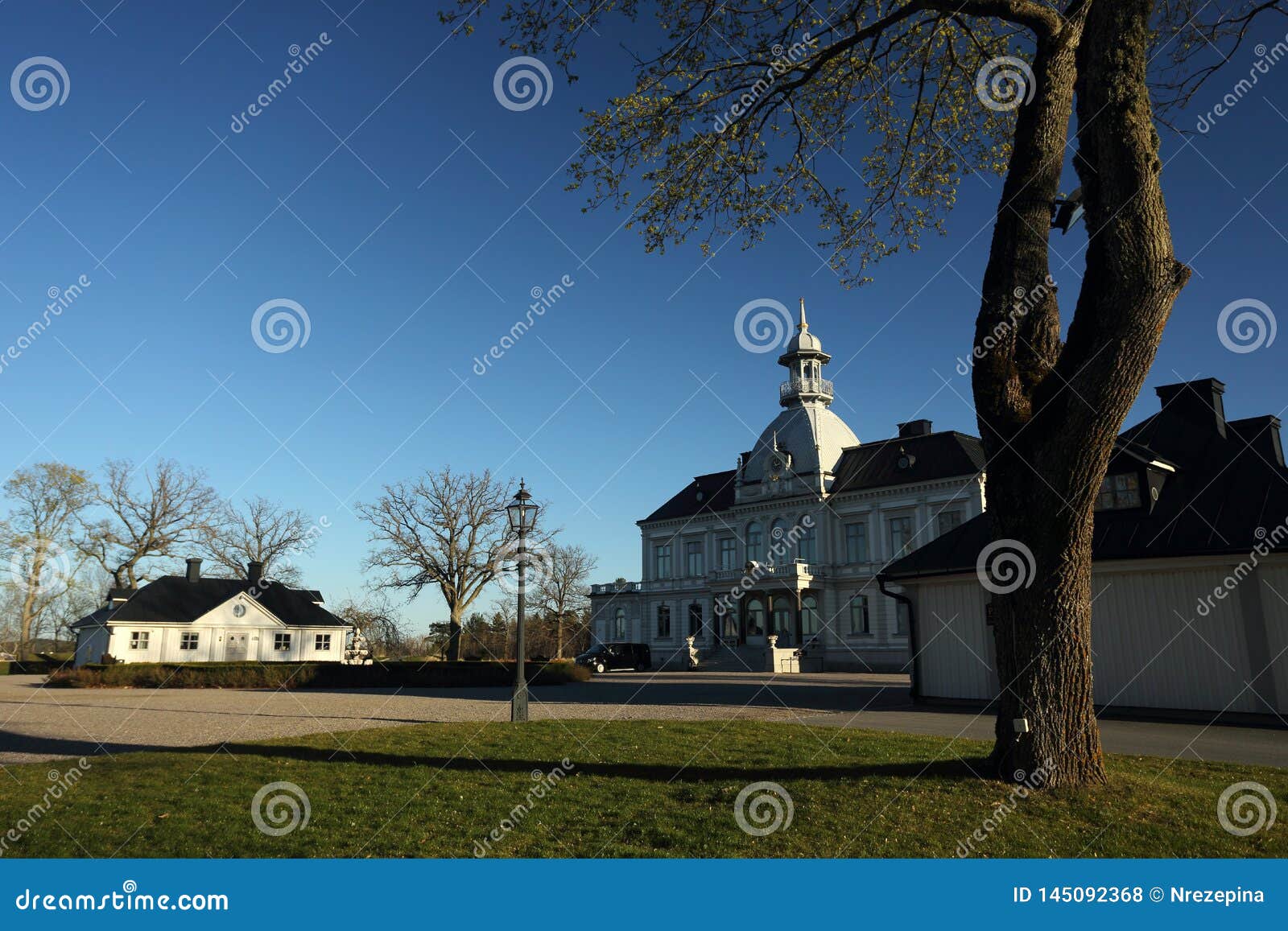 a golf course with roads and ponds and with golfcart and building in sweden