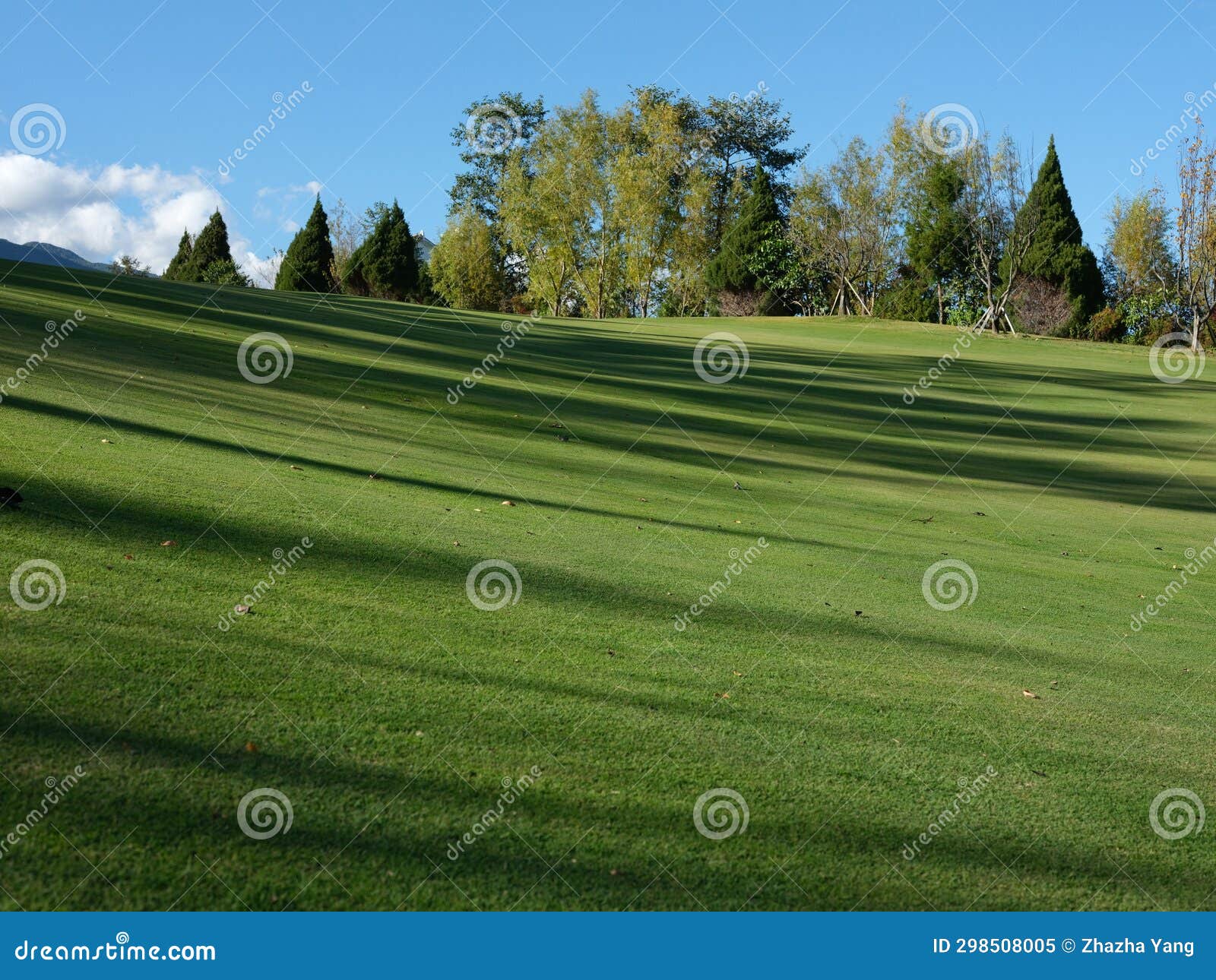 A Golf Course Under Blue Skies and White Clouds in Yunnan, China Stock