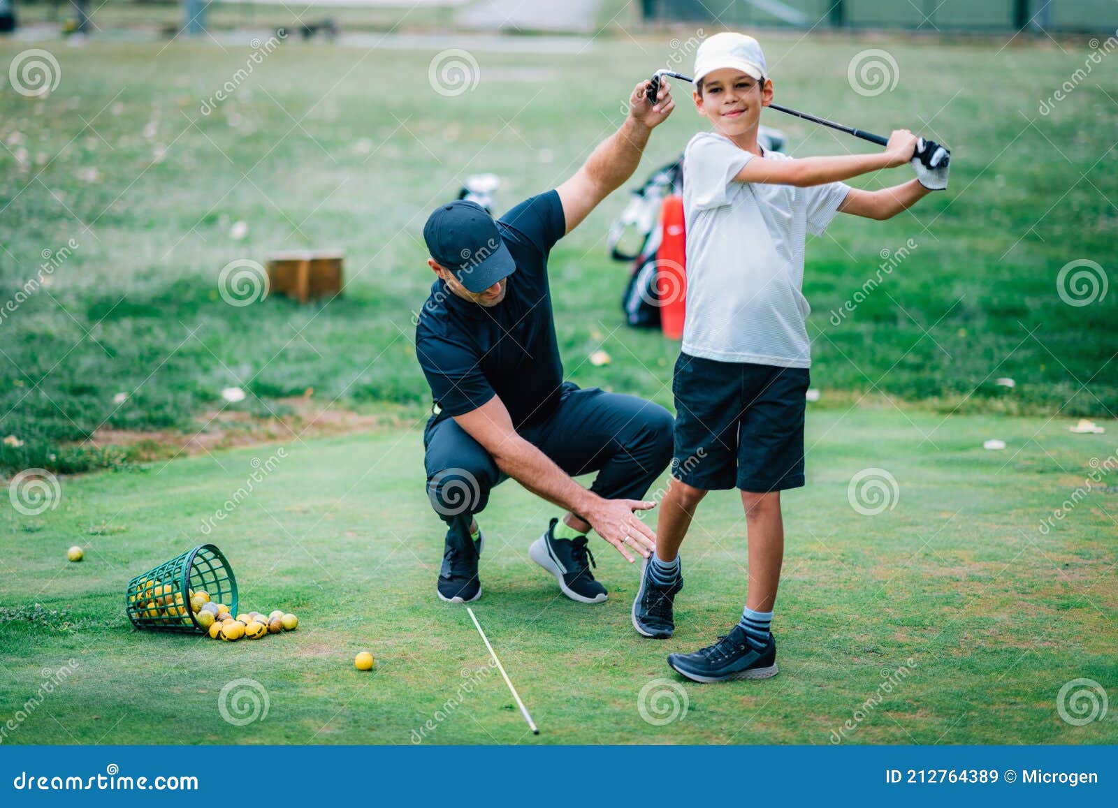 Golf Lesson. Golf Instructor Teaching Young Boy How To Swing Stock Image Image of adjusting