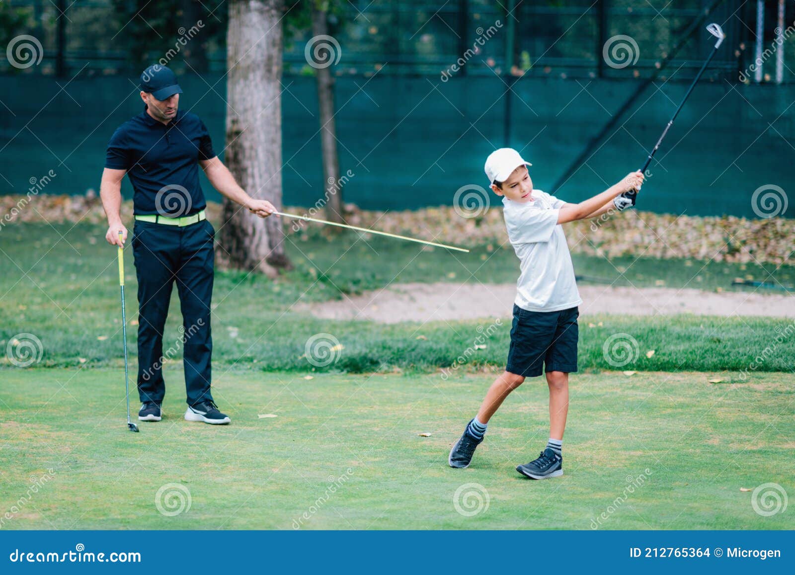 Golf â€“ Personal Training. Golf Instructor Teaching Young Boy How To