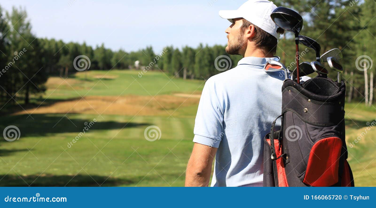Golf Player Walking and Carrying Bag on Course during Summer Game