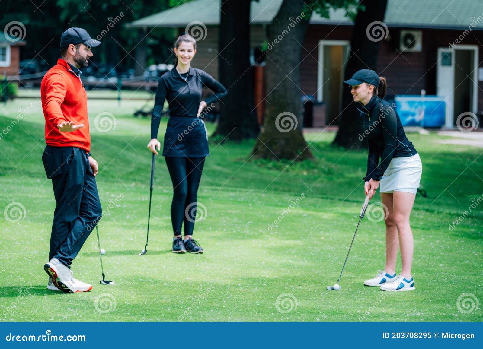 Golf Putting Lesson, Two Young Female Golfers Practicing Putting with