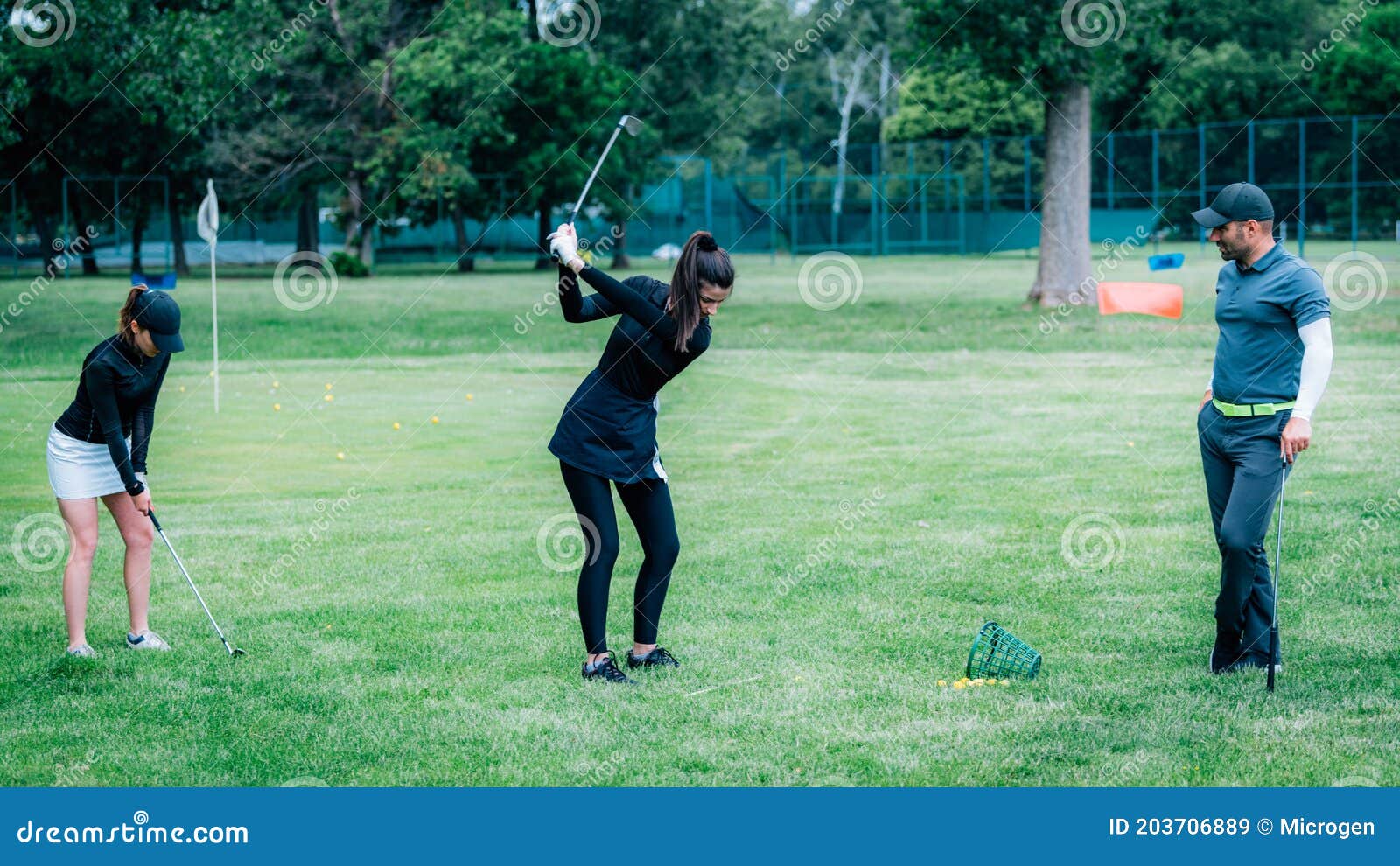 Golf Swing Technique â€“ Golf Instructor Working with Two Young Ladies
