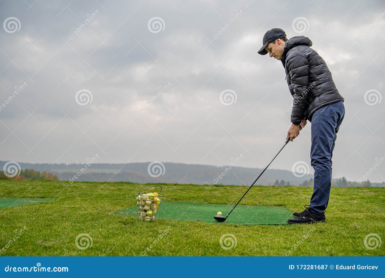 Golfer on a Green Pitch Batting Golf Ball Stock Image Image of