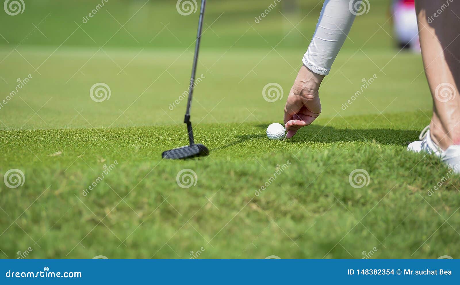 Golfer is Pushing Golf Ball by Golf Club from Tee Boxes at Golf Course
