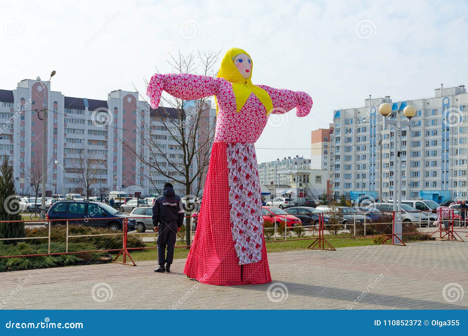 scarecrow of shrovetide against sky and city buildings gomel