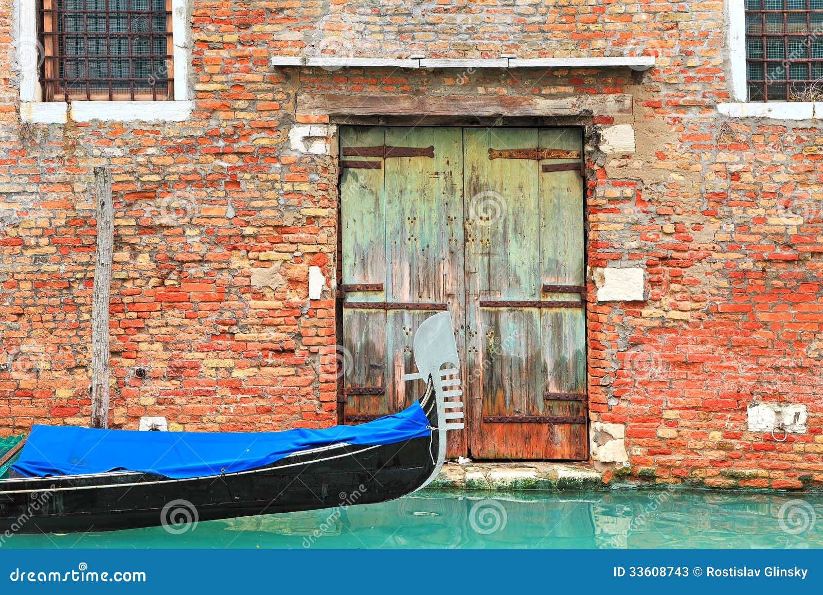 Gondola On Canal And Old Brick House In Venice, Italy 