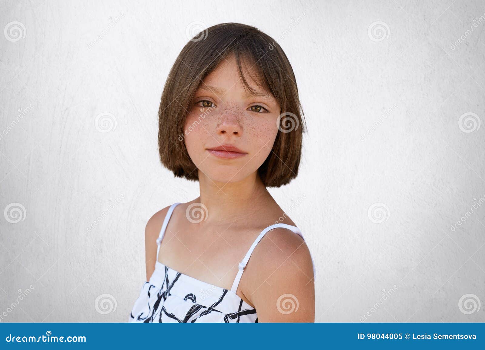 Good-looking Brunette Kid with Freckles and Short Hair Posing Against White Concrete Wall Dressed in White Dress. Little Child Wit Stock Image - Image of close, hairstyle: 98044005 Good-looking Brunette Kid with Freckles and Short Hair Posing Against White Concrete Wall Dressed in White Dress. Little Child Wit Stock Image - Image of close, hairstyle: 98044005