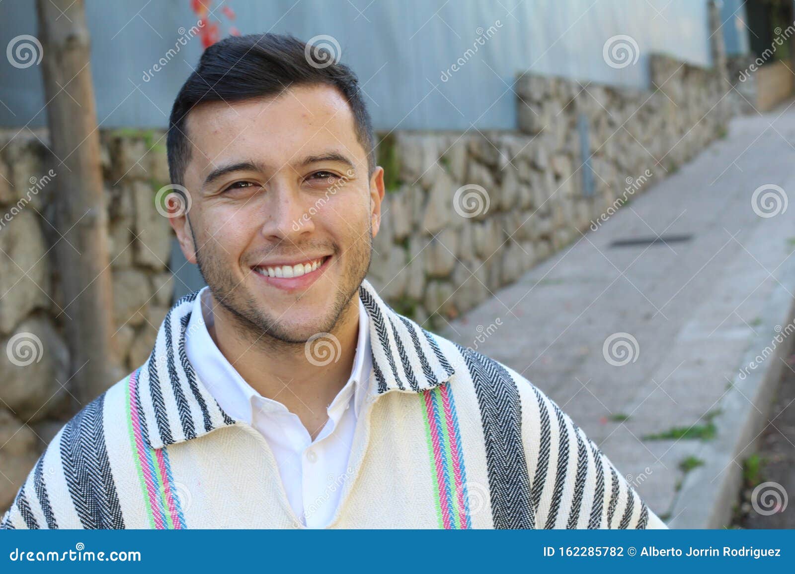 good looking hispanic man wearing a ruana