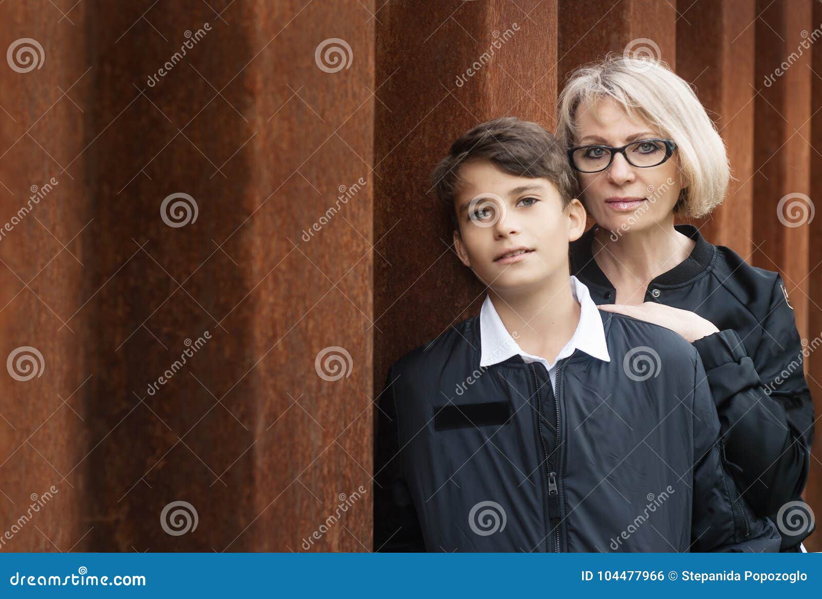 good-looking, single-parent mom and teen son in the park. photo