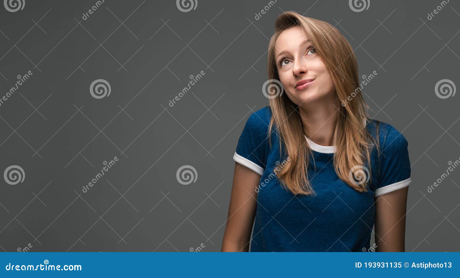 good-looking woman looks away enigmatically, wanting to do something illegally or secretly. copy space for your text