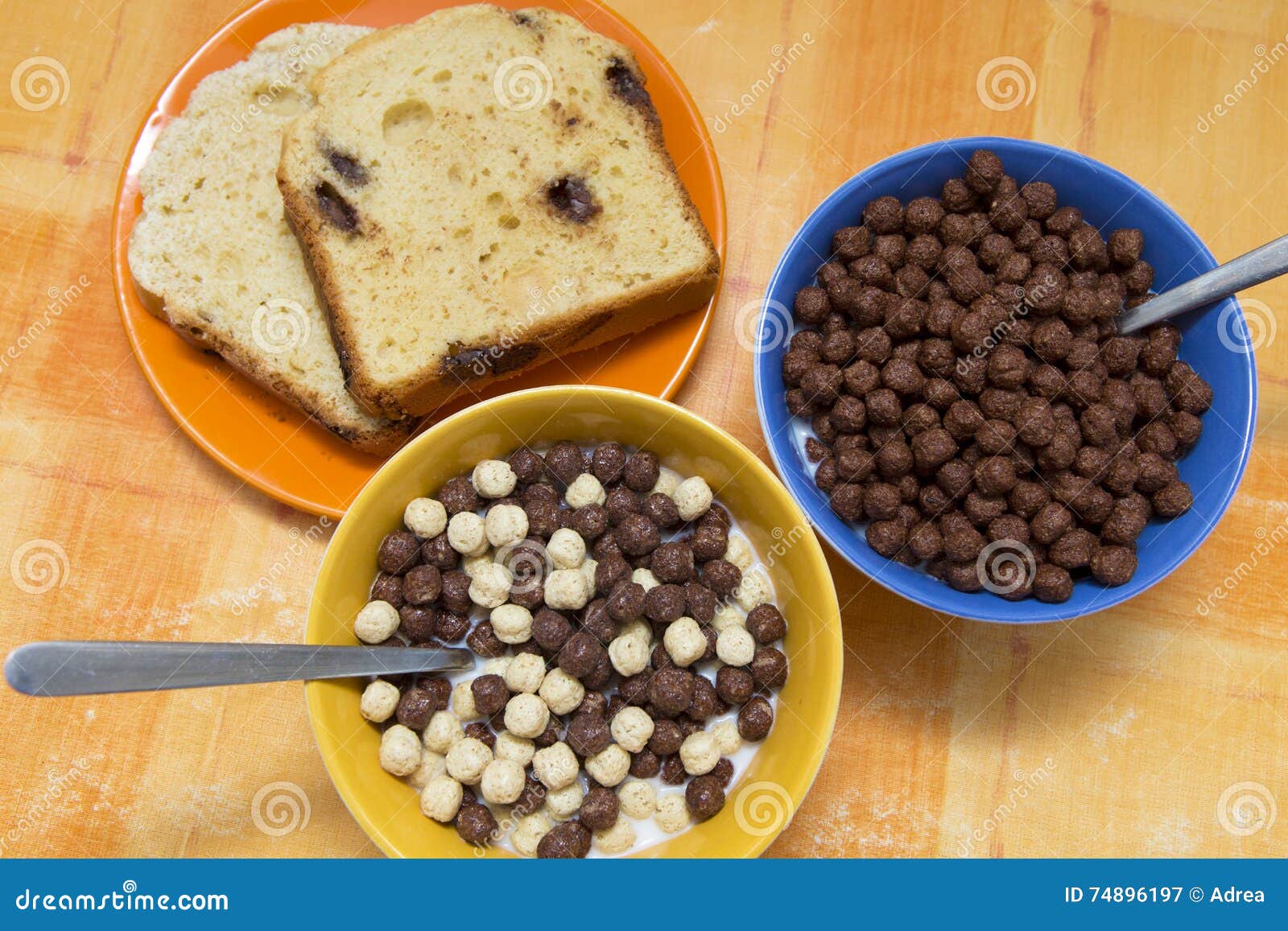 bole of cereals and a plate with sweet bread
