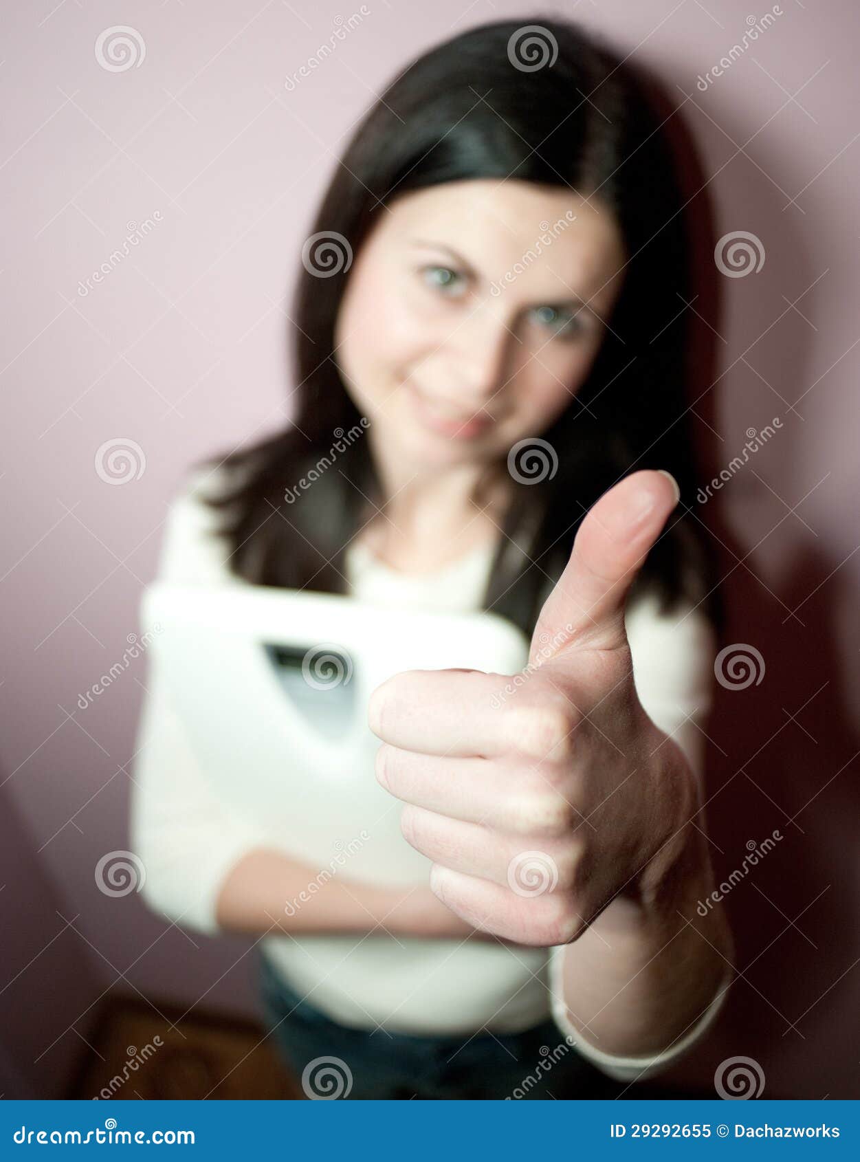 Good weight. Close-up of woman with Close-up of woman with thumbs-up sign
