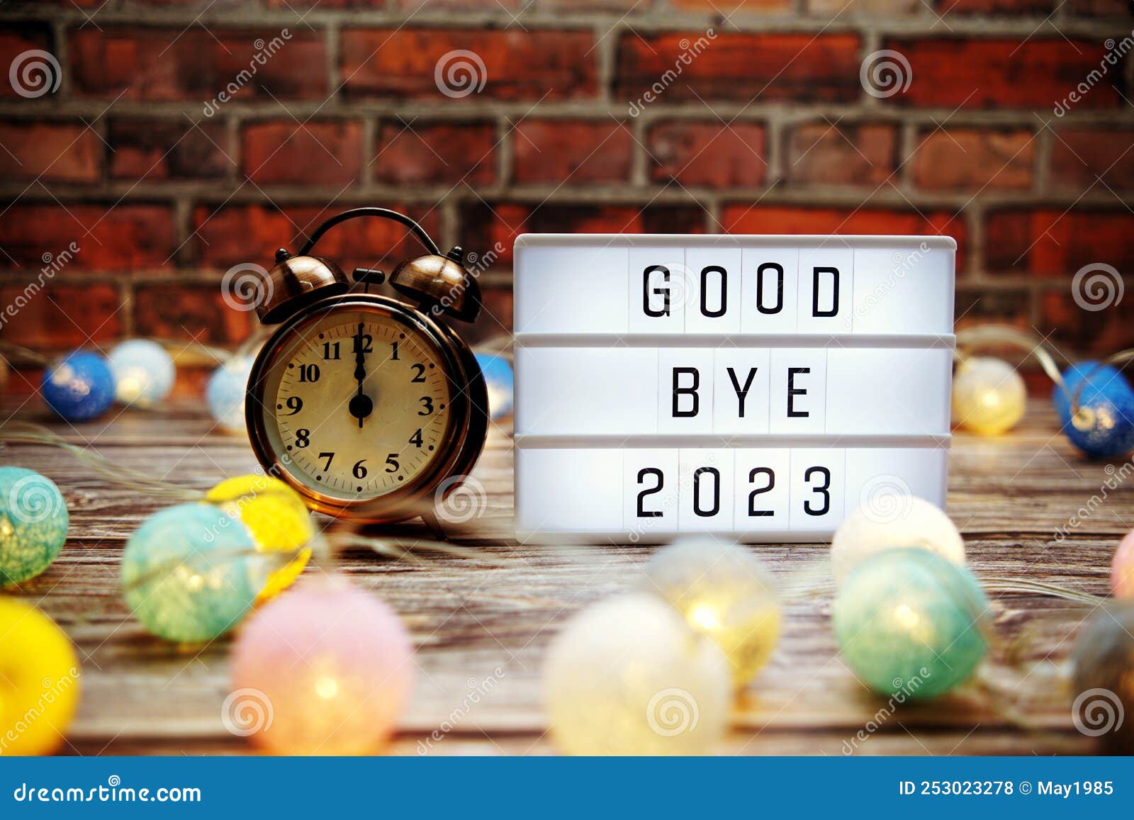 goodbye 2023 text in light box with alarm clock and led cotton balls decoration
