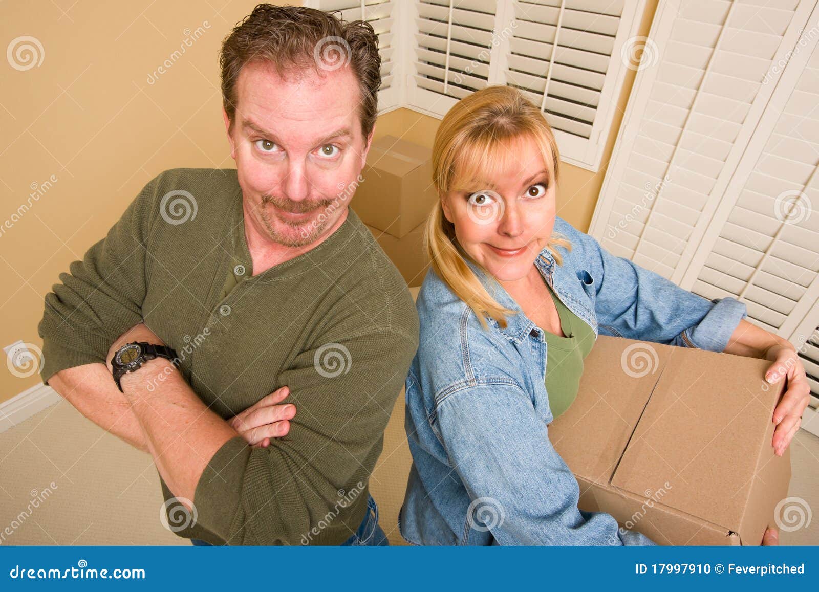 goofy couple and moving boxes in empty room