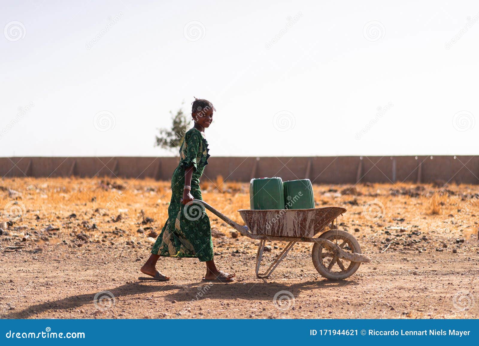 gorgeous african ethnicity girl carrying fresh water for an aridity concept