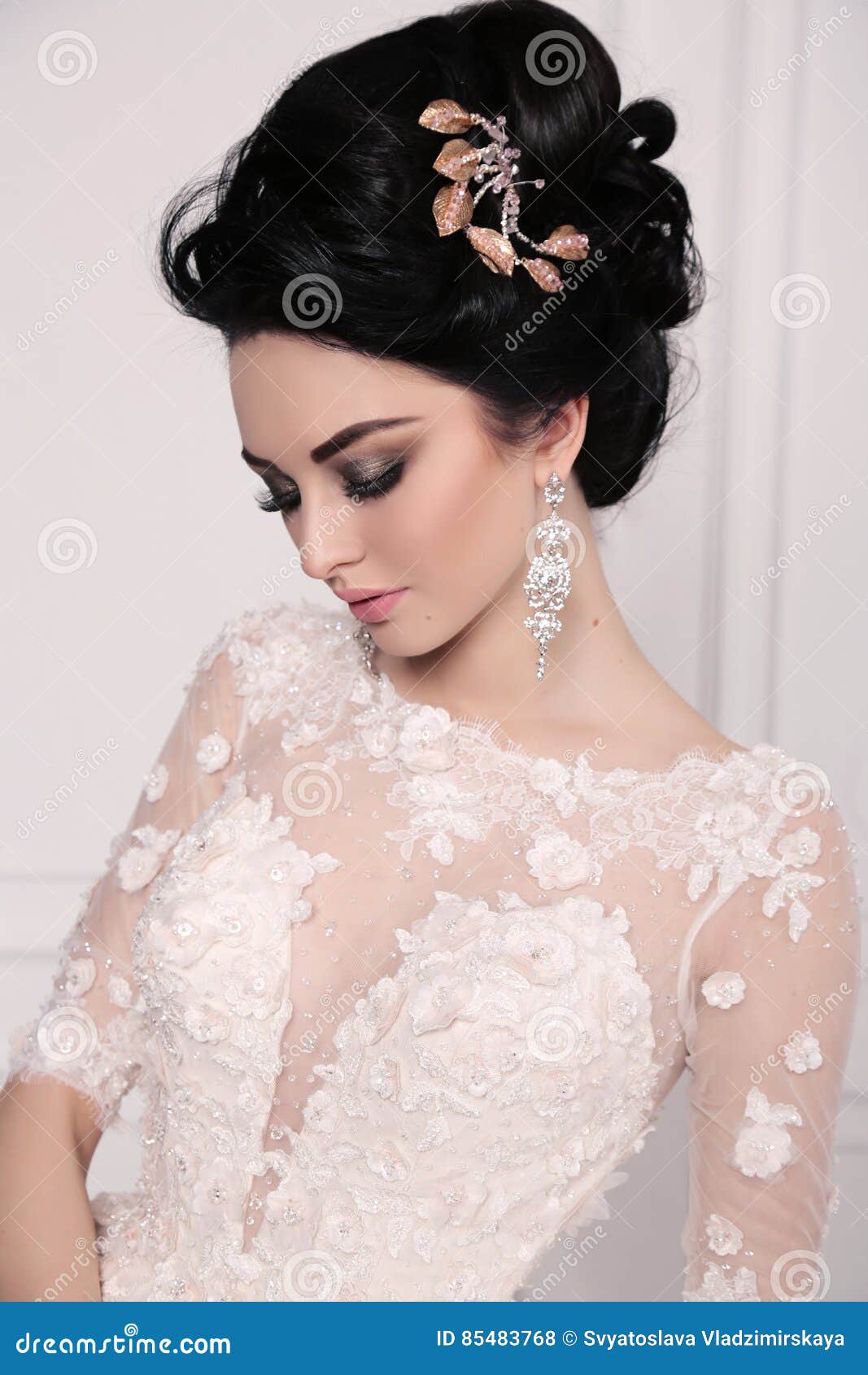 gorgeous bride with dark hair in luxuious wedding dress