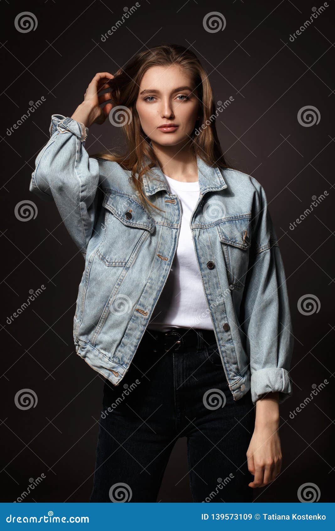 Young stylish brunette girl on shirt, pants, jeans jacket posed background  iron fence. Street fashion model concept. 6631462 Stock Photo at Vecteezy