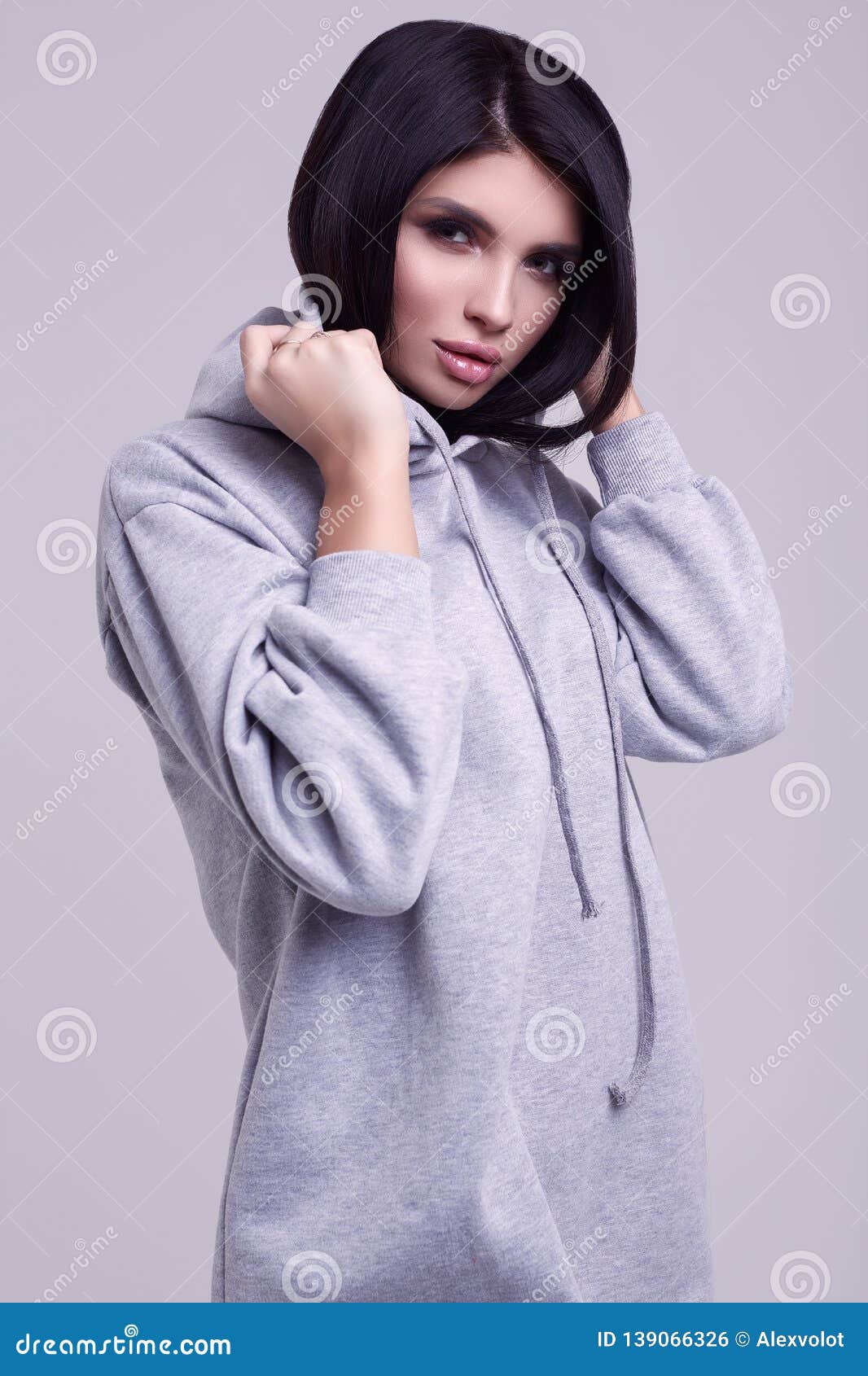 Gorgeous Brunette Woman in Fashion Blue Hoodie in Studio Stock Photo ...