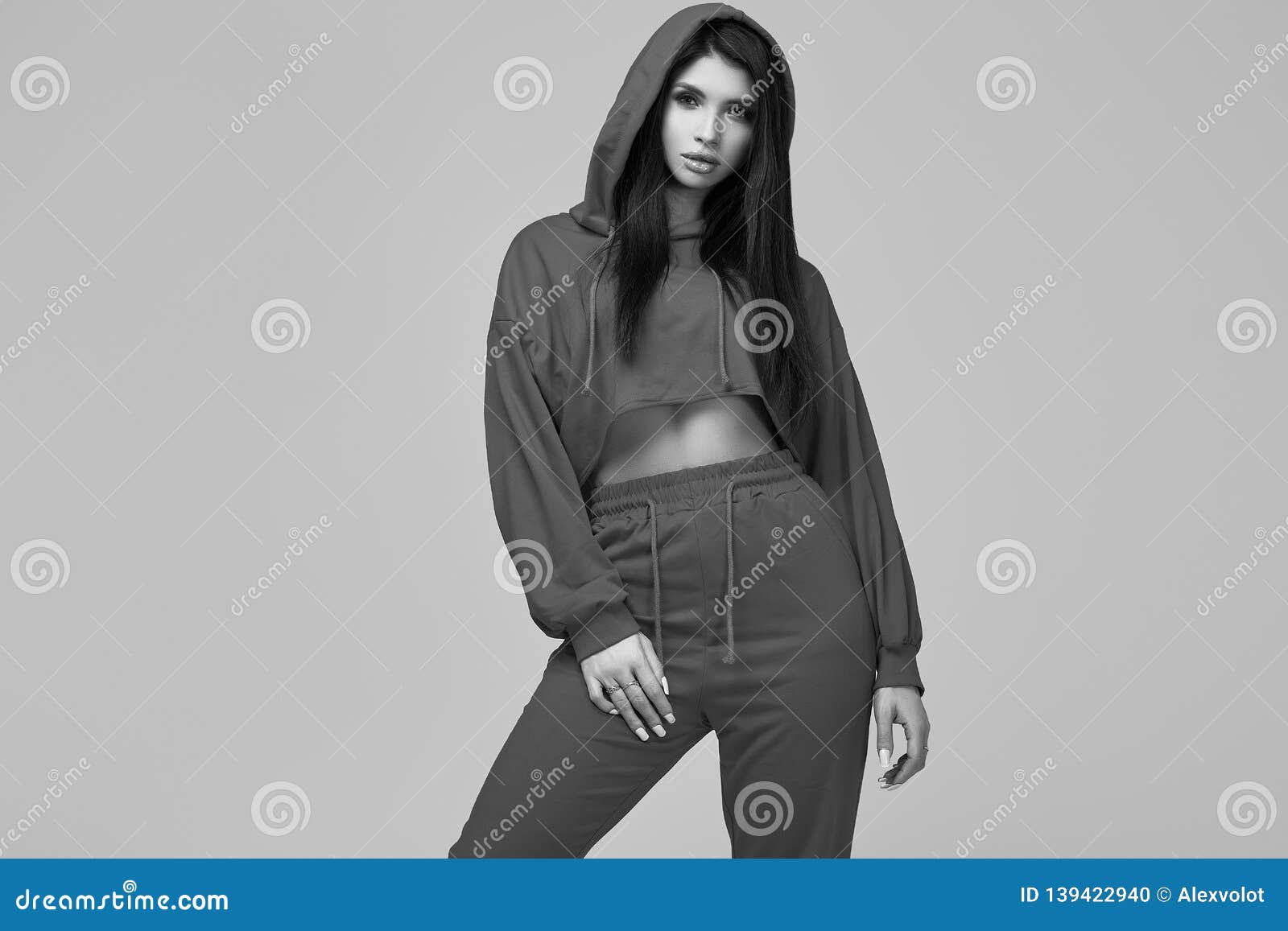 Gorgeous Brunette Woman in Fashion Red Hoodie in Studio Stock Photo ...