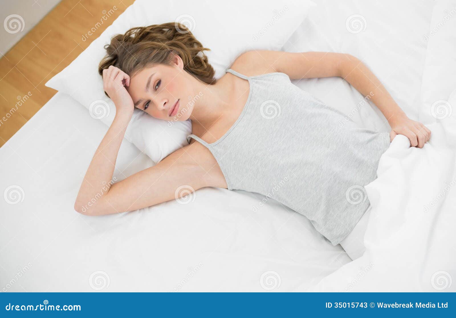 Gorgeous Slender Woman Lying On Her Bed Under The Cover Stock Image