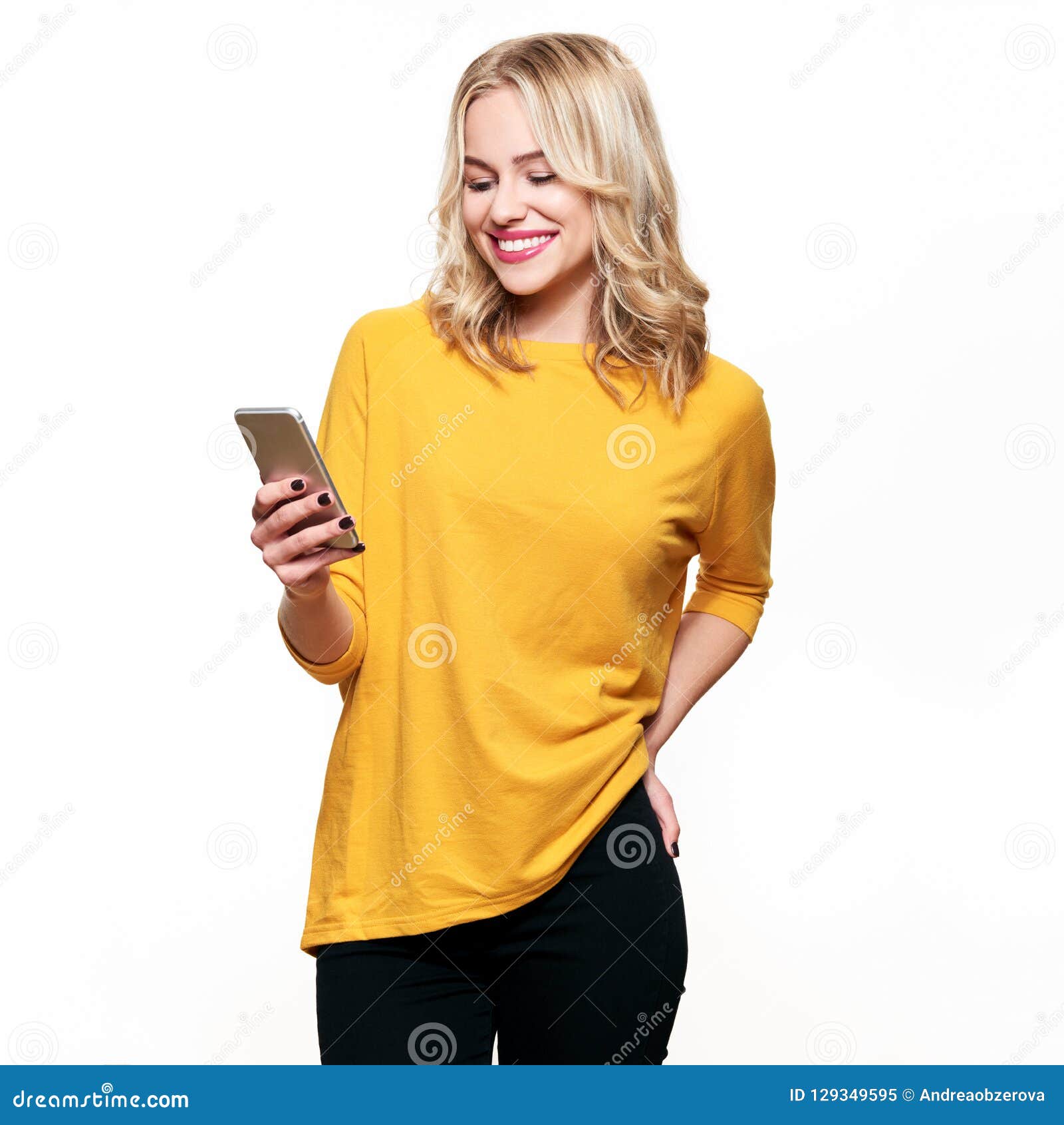 gorgeous smiling woman looking at her mobile phone. woman texting on her phone,  over white.