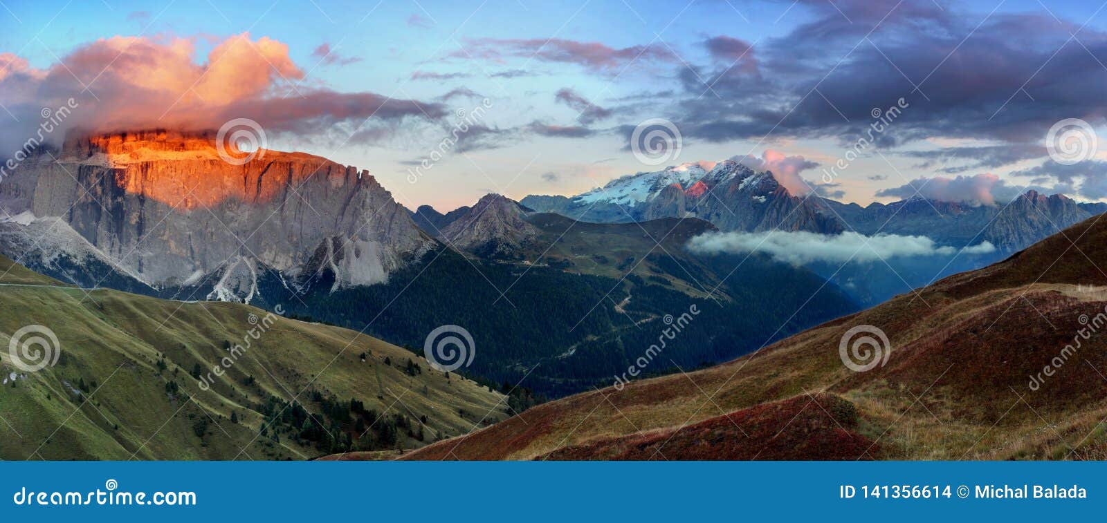 gorgeous sunny view of dolomite alps with pastures. colorful autumn scene of langkofel, sassolungo mountain range. sella pass.