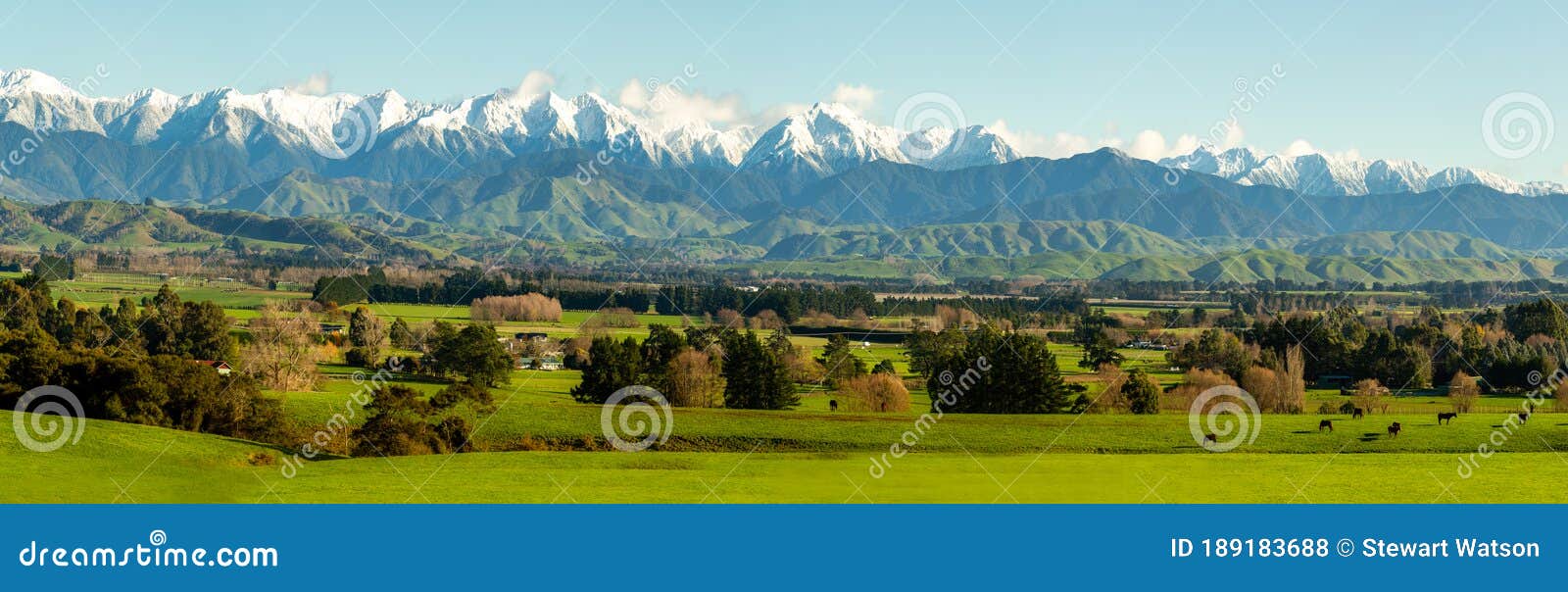 the gtararua ranges in the wairarapa with snow on the peaks and the lush rural agricultural valley below