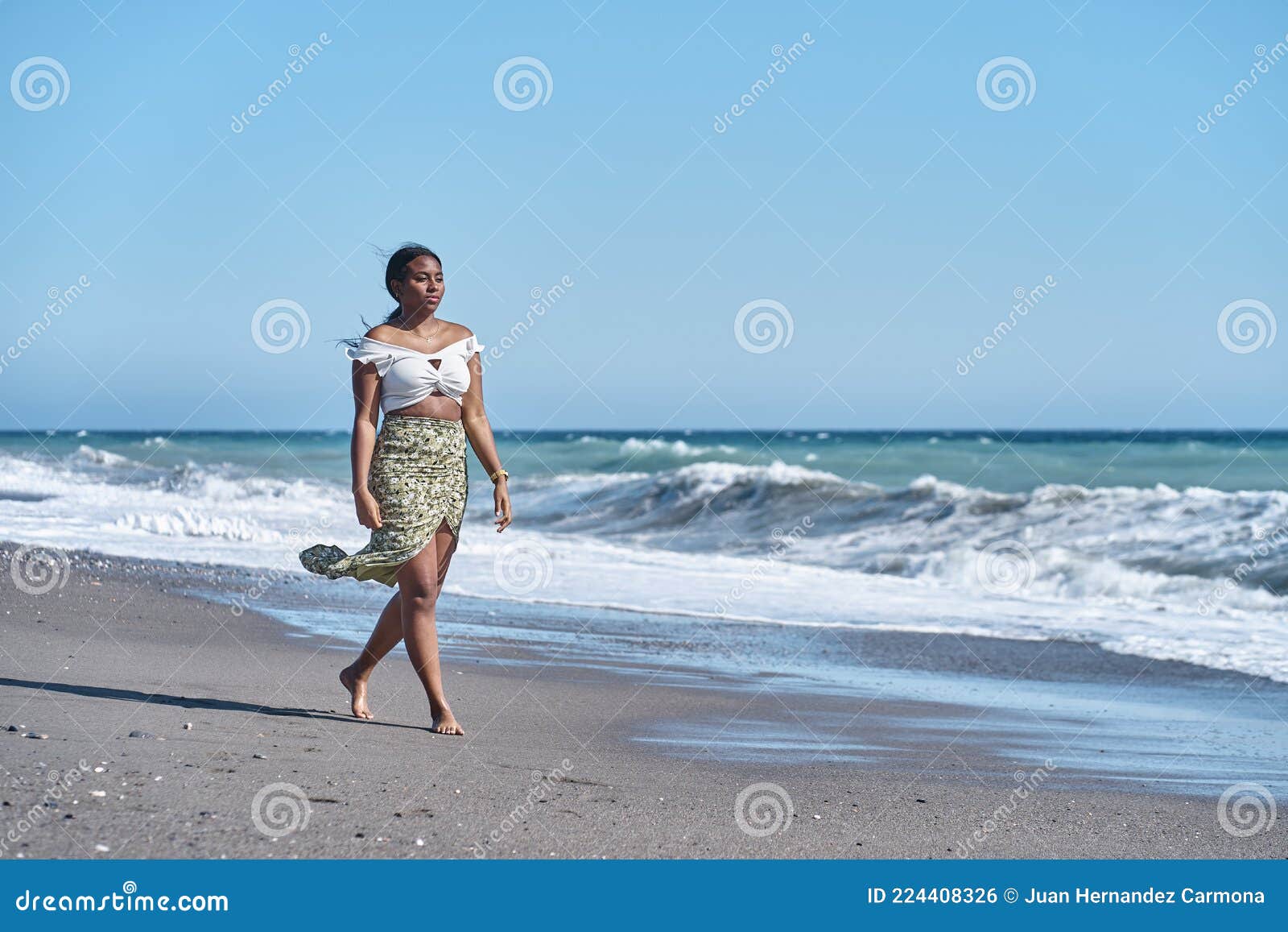 Gorgeous Young African American Woman Strolling Along the Beach in a ...