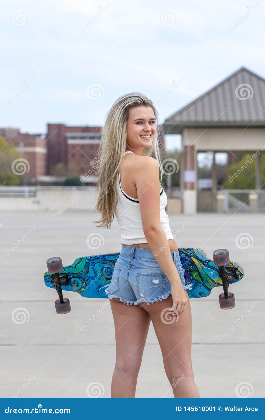 Gorgeous Young Coed Model Enjoying The Warm Weather With Her Skateboard 