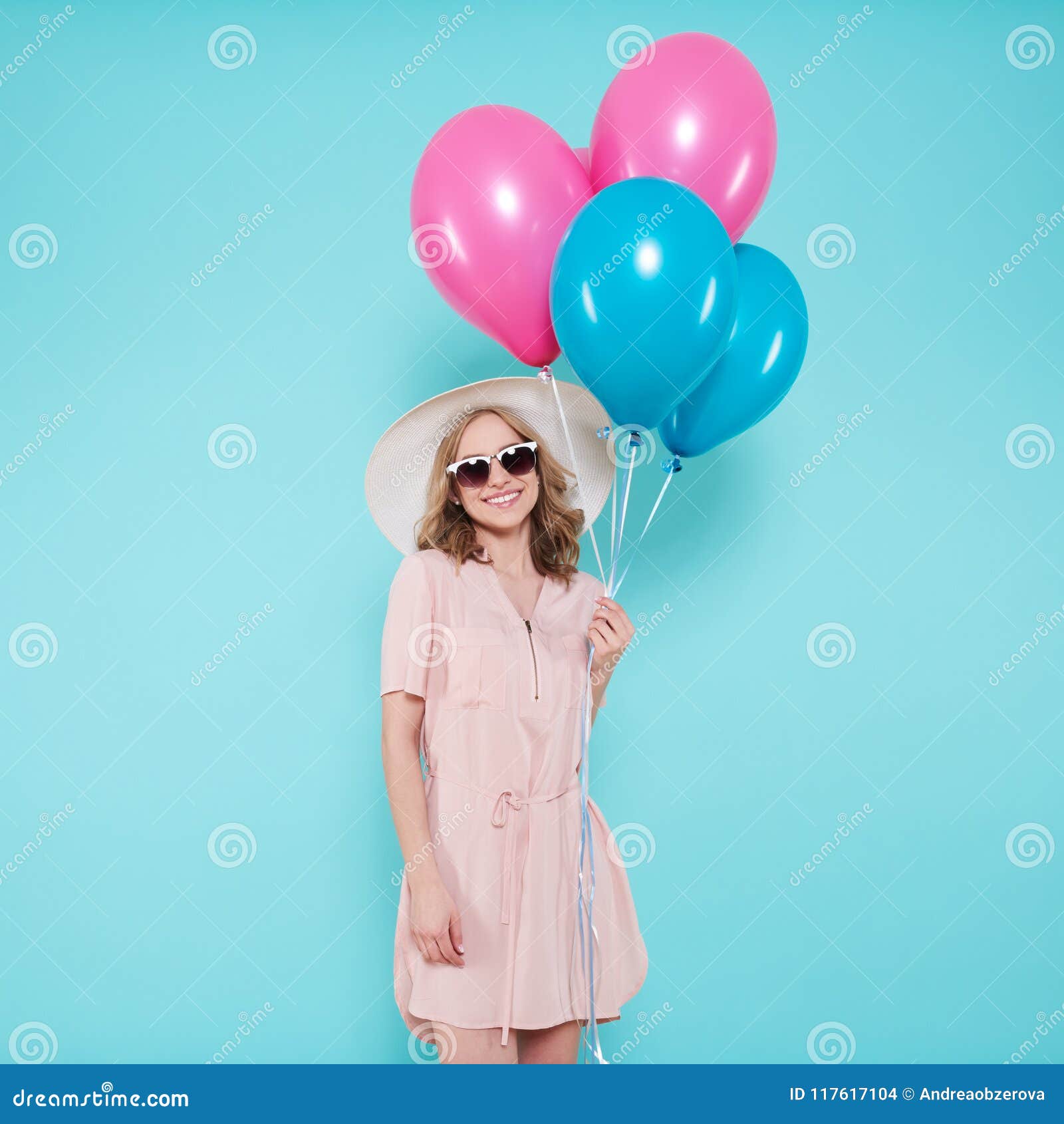 Gorgeous Young Woman in Party Summer Dress and Straw Hat Holding Bunch of Colourful Balloons, Isolated Over Pastel Blue. Stock - Image of adult, balloon: 117617104