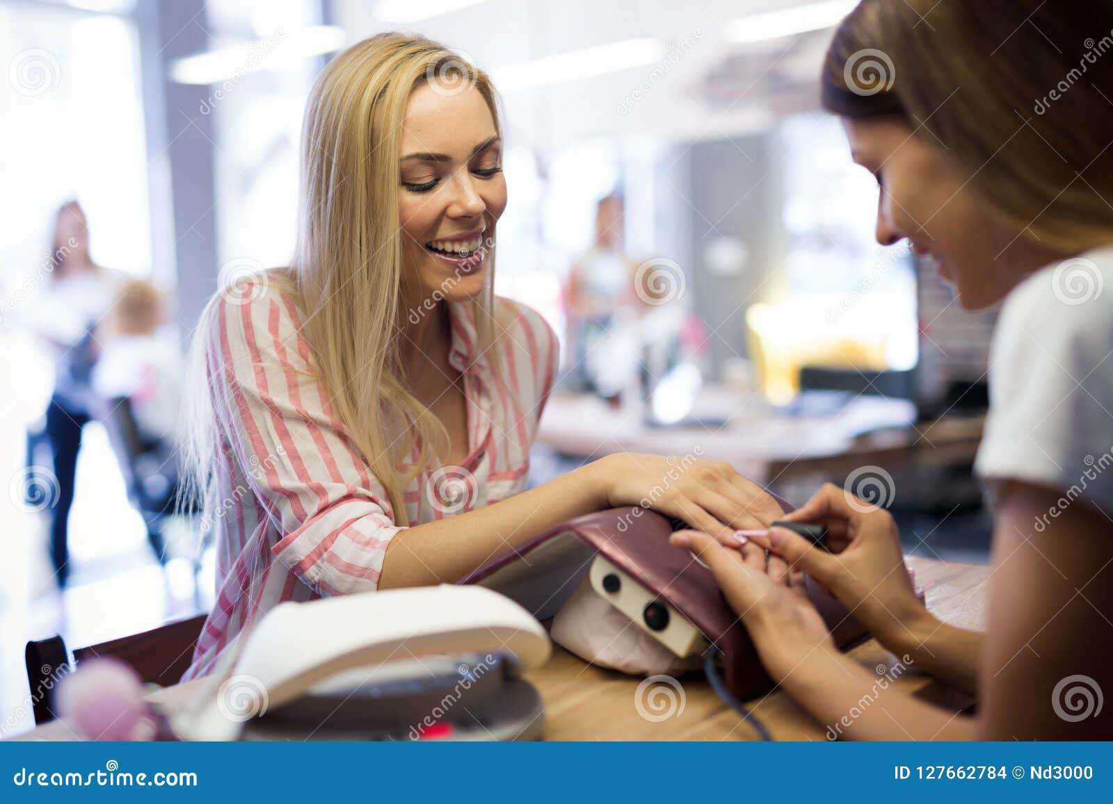 Young Woman Getting Her Nails Done by a Manicurist Stock Photo
