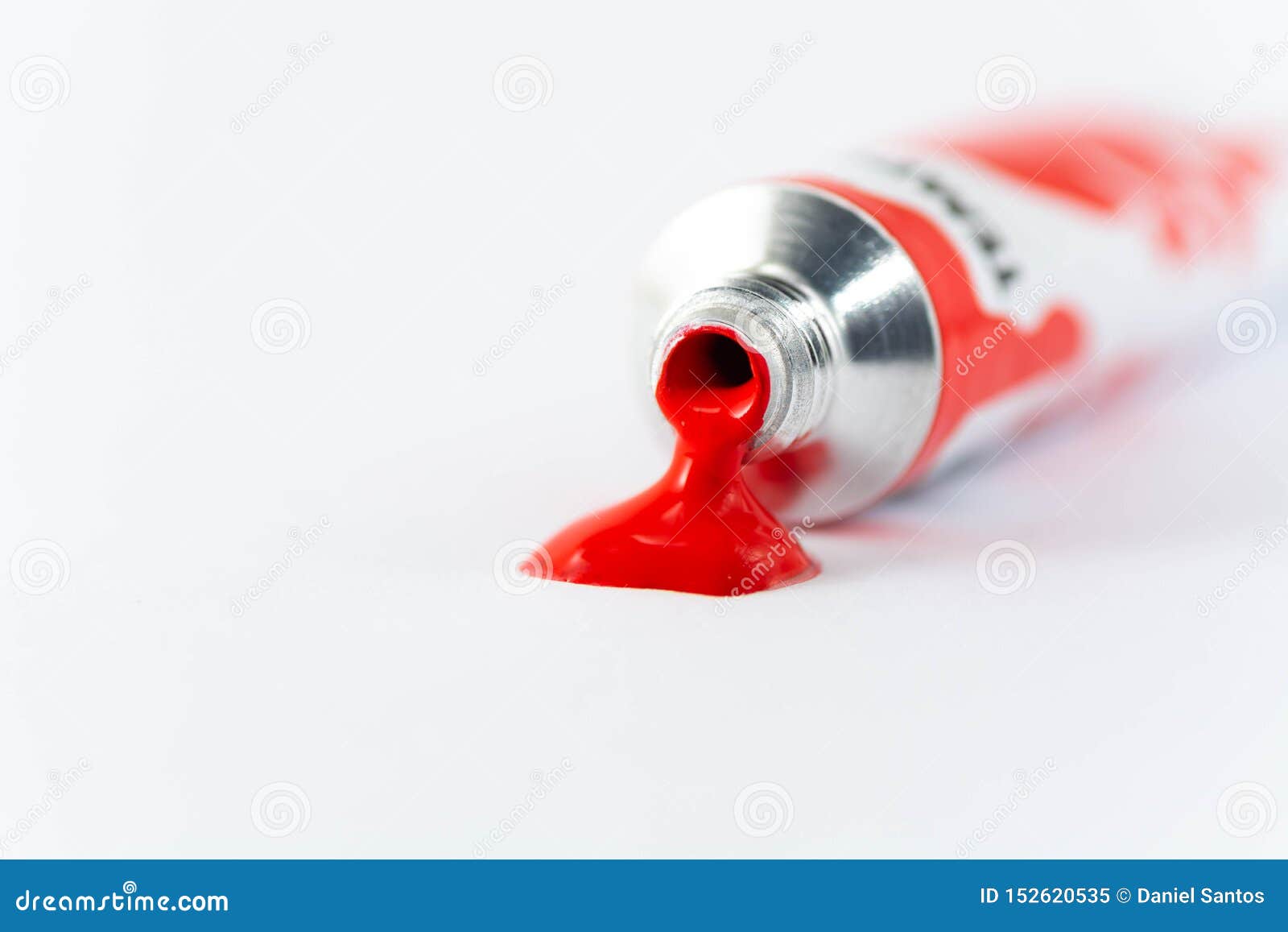 Gouache Tube Dripping Red Paint and White Background Stock Image