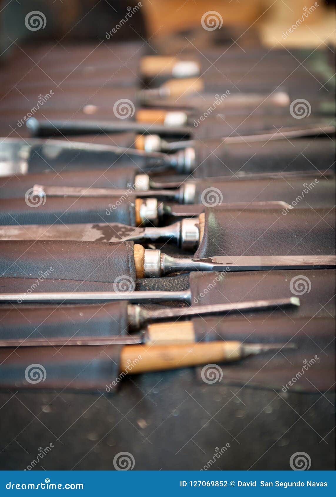 gouges and chisels in the foreground leather case