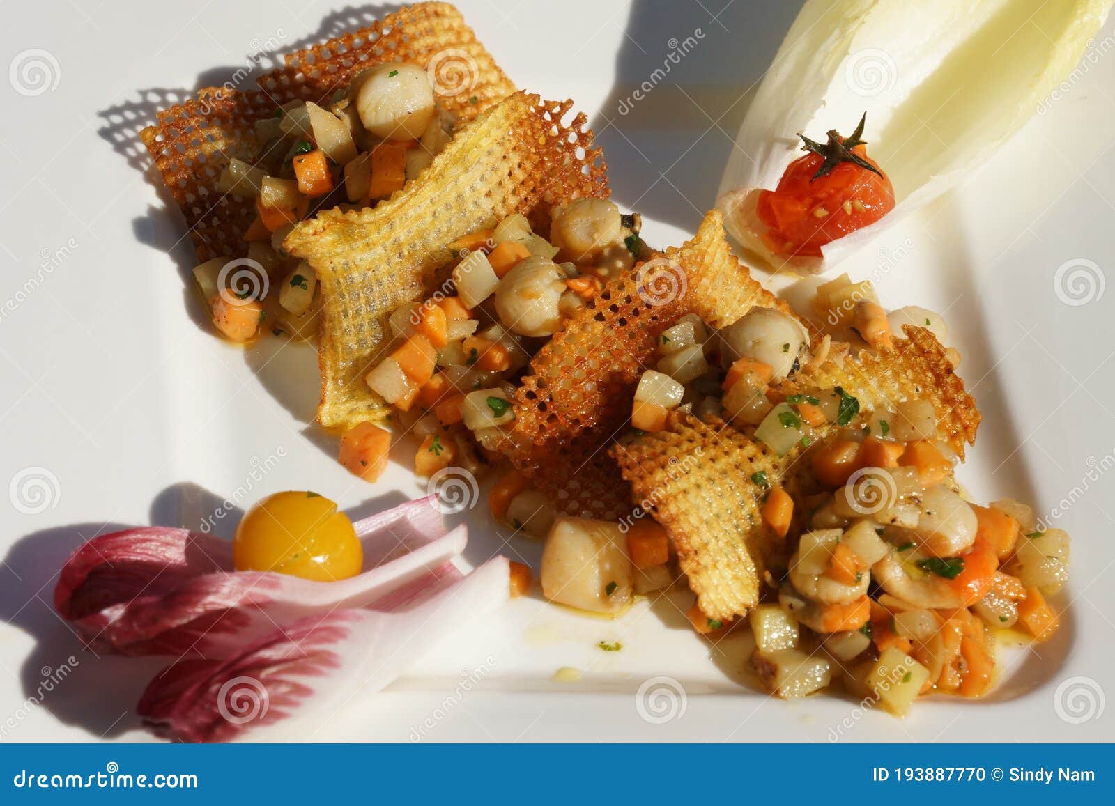 gourmet dish mille-feuilles of potato waffles and pan fried scallops