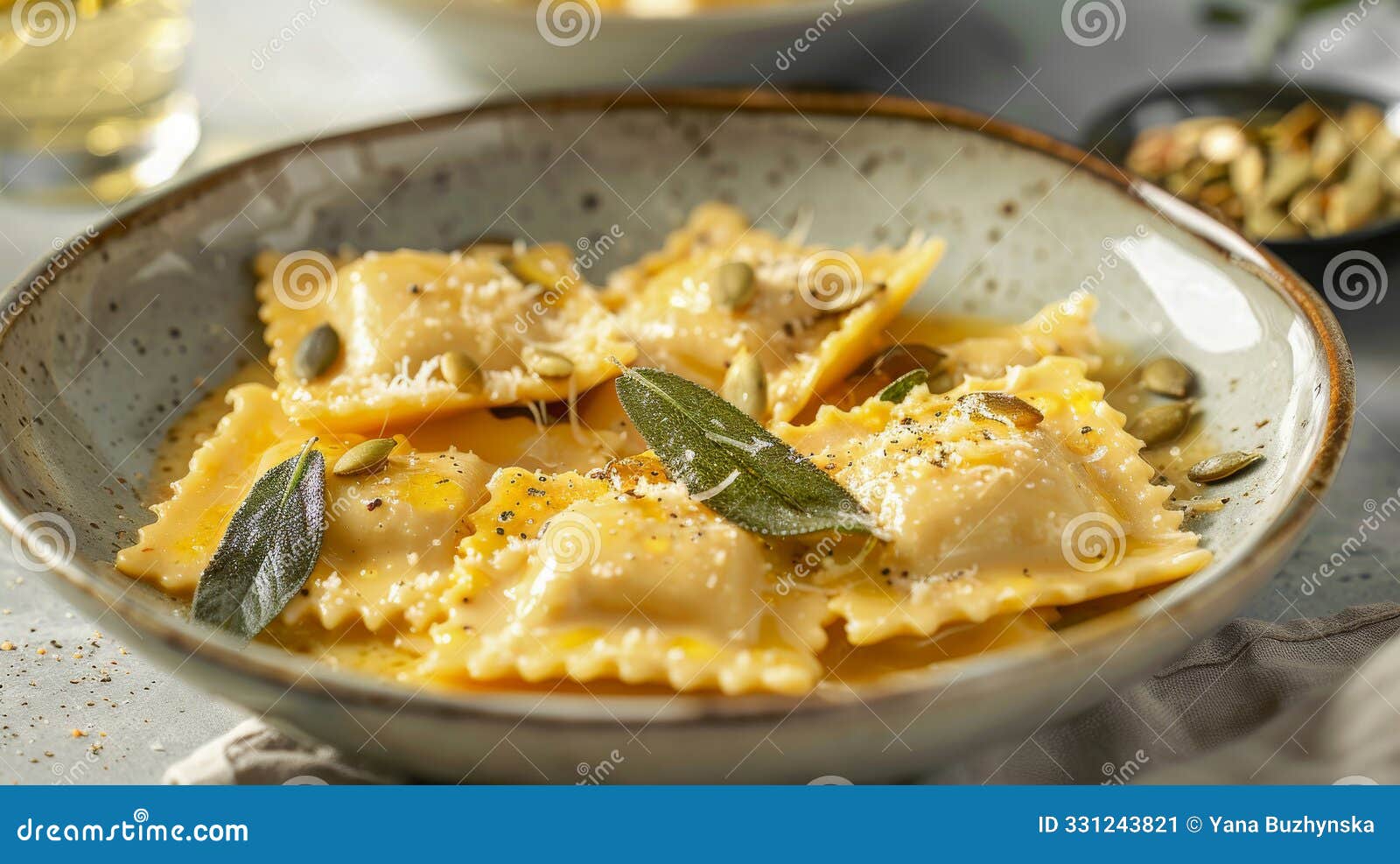 gourmet homemade pumpkin ravioli in nutty brown butter sage sauce, topped with toasted pumpkin seeds and fresh sage