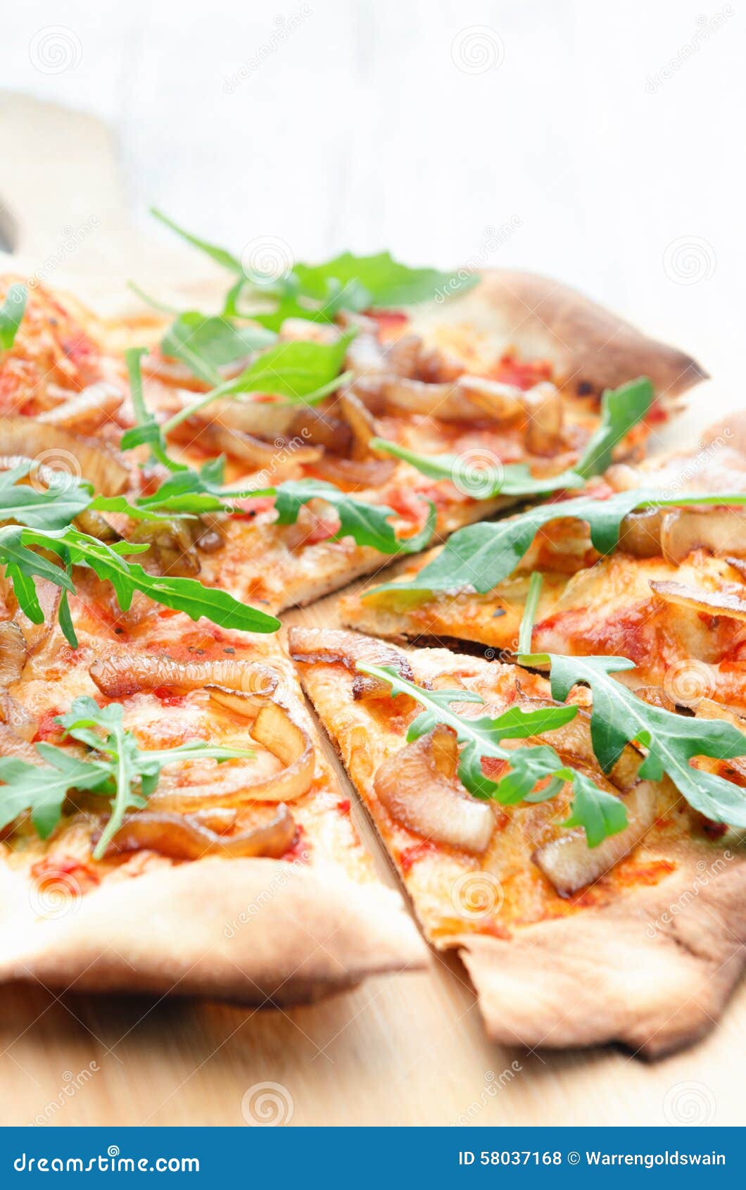 gourmet thin crust pizza with fresh rocket and caramelised onion