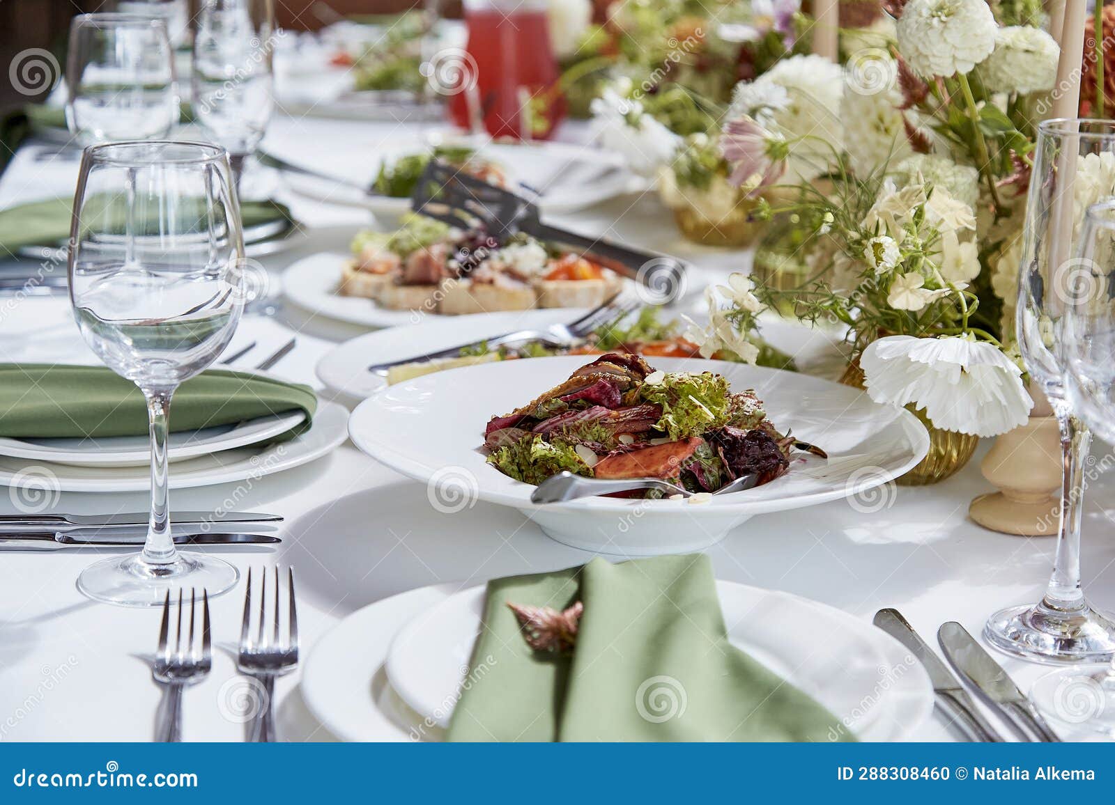 graceful aesthetics table setting, arranged flowers under natural light. cozy holidays table setup